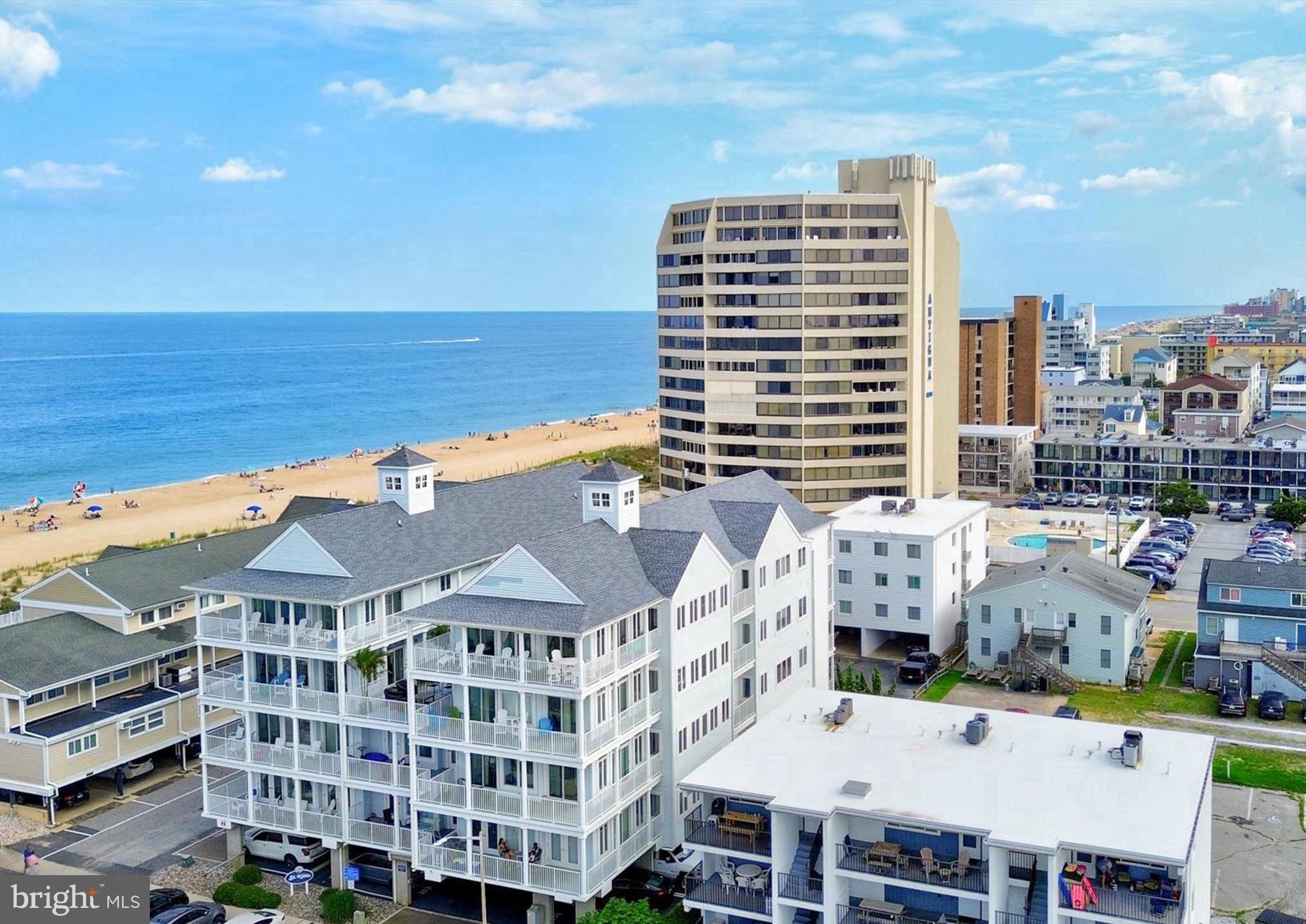 This amazing spacious unit has 5 bedrooms and 4.5 baths, new HVAC unit, newly replaced sliding doors, and surround sound featured in the open living areas as well as wrap around balconies with views of the beach, Atlantic Ocean & Assawoman Bay. The condo has 3  covered assigned spaces, for no hassle parking and a building elevator for ease of trips to and from the beach. "Sunset" Unit 301, at 2722 sq ft, is a proven high income producing rental that is being offered turn key/ fully furnished so all you have to do it start collecting the rental income. Sunset also features LVP flooring, granite counters & island, tray ceilings as well as sliders and windows galore. To the east of this unit sits a beautifully decorated terrace perfect for entertaining and or family gatherings. This is an incredible offering to allow large families or great travel friends to own together in one of the most desirable garden style condo buildings in town or an incredible investment opportunity that could bring in over $100k+- in gross rental income per year per unit
