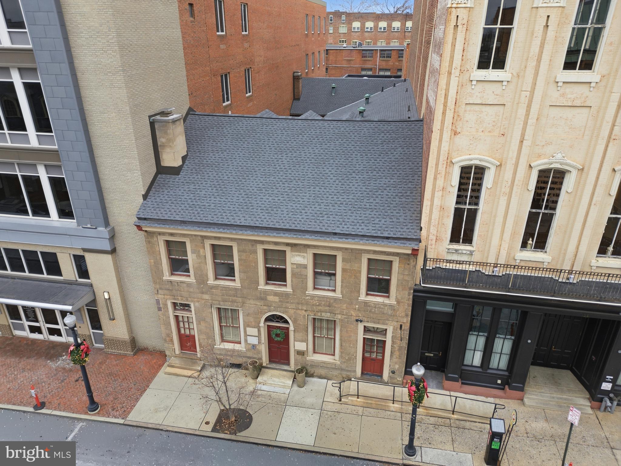 Experience a property of extraordinary distinction - one that stands alone in Lancaster City history. Bearing a rare and storied date stone, this is the oldest city townhouse in Lancaster, with origins dating back to 1762. Originally constructed by William and Elizabeth Bowsman, the sandstone Georgian townhome has been meticulously preserved, honoring its architectural integrity while seamlessly accommodating modern use.

An extraordinary opportunity to own a luxurious residence and landmark property in the heart of vibrant Downtown Lancaster, this home is ideally positioned in the Central Business District just one block from Penn Square. Enjoy walkable access to an exceptional array of upscale restaurants, charming coffee shops, artisanal bakeries, boutique shopping, and cultural landmarks, including Lancaster Central Market, the courthouse, Fulton Theatre, and Ware Center - all mere steps away.

The property offers exceptional mixed-use potential, with approximately 5,500 square feet of commercial space across the first and lower levels. The primary office space was thoughtfully designed by renowned architect C. Emlen Urban for Milton Hershey, intended to entice him to return his confectionery business to the area. A rare and invaluable amenity in the city, the property also includes a 14-car rear garage equipped with an EV charging station, further enhancing its appeal as a premier business opportunity in a prime commercial zone.

Above the commercial space lies a magnificently restored 3,500-square-foot residence featuring three bedrooms, three full baths, and one half bath. Completely upgraded between 2015 and 2016, the home blends historic character with refined, metropolitan finishes. New Roof 2025. Soaring ceilings and an open, light-filled layout create a sense of effortless sophistication and residential comfort rarely found in the city.

Combining unparalleled history, an irreplaceable downtown location, flexible commercial opportunity, and exceptional residential living, this is a truly singular offering - representing the very finest of Lancaster City living.