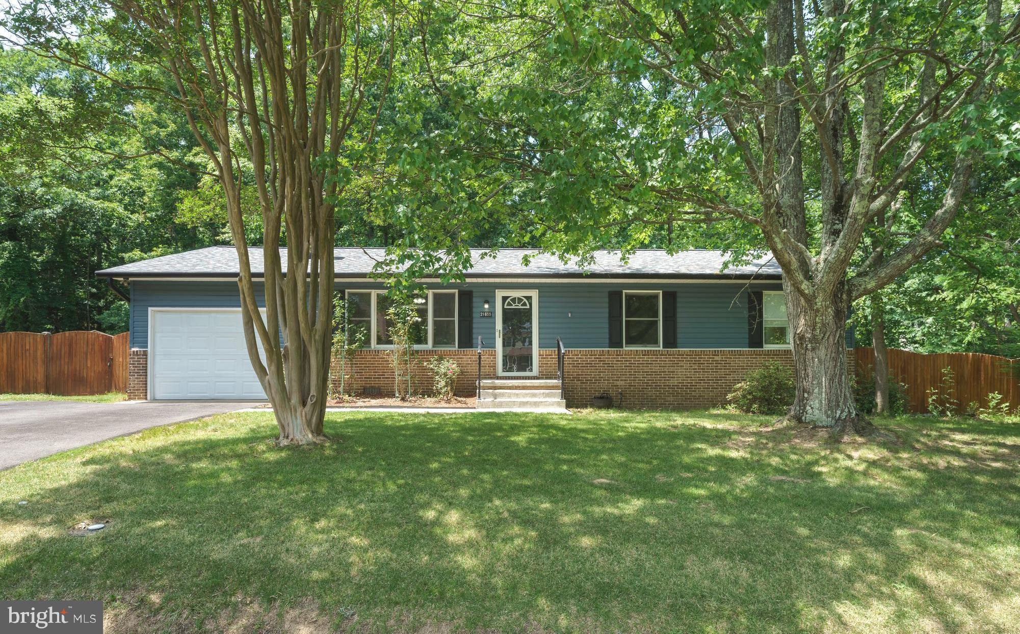 WELCOME HOME to 21655 Defender Street! Ideally located just outside Gate 3 of Patuxent River Naval Air Station.  This beautifully maintained three-bedroom, two-bath home offers the perfect combination of convenience, comfort, and peace of mind. Major system updates completed within the past three years include a new roof, HVAC system, hot water heater, vinyl siding, black gutter system, and paved driveway—allowing the next owner to move in with confidence. Step inside to discover a spacious and inviting floor plan featuring an upgraded kitchen with glazed cabinetry, granite countertops, stainless steel appliances, built-in microwave, and additional table space. The adjoining dining area and family room create an ideal setting for both everyday living and entertaining. The family room is highlighted by a charming wood-burning fireplace with raised hearth and mantel, creating a warm and welcoming focal point. The primary suite offers a private full bath with a frameless walk-in tile shower, while two additional bedrooms share a well-appointed hall bath with tub/shower combination. Additional features include an encapsulated crawl space, rear deck, shed, one-car garage with extended length and epoxy flooring, and a convenient rear garage door providing direct access to the fenced backyard. One of this home's most valuable features is its exceptional setting.  Nestled at the end of a quiet cul-de-sac and backing to mature trees, you'll enjoy a level of privacy rarely found at this price point. Residents also enjoy access to the community's private beach area, adding to the coastal charm and recreational opportunities. Located just minutes from area beaches, parks, restaurants, shopping, theaters, museums, and all that Southern Maryland has to offer, this property presents an outstanding opportunity to enjoy comfortable living in a highly desirable location.