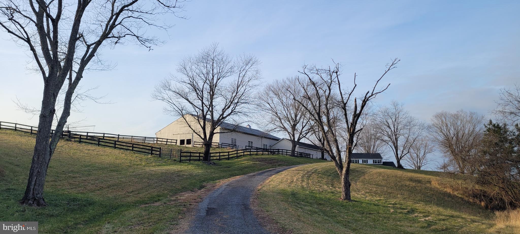 HORSE FACILITY “for lease” (no residence included).  This property is located on picturesque private 118.49-acre quiet retreat.  This secluded property is minutes to Warrenton. Views in every direction and no neighbors in sight. The land is gently rolling, mature woods, ample pasture, spring fed stocked pond, numerous creeks, and mountain views.

The owner lives off-site and looking for a quiet tenant that shares the vision to maintain the pristine “Old World” feel of this property.  The ideal tenant is a private trainer or horse enthusiast looking for a peaceful location. The initial lease is for 12-24 months.  Ideally looking for a long-term lease.

The improvements on the property include 7 stall barn, 60 x 90 indoor arena (sand & stone dust), tack room, hay area, equipment shed, fly control system (as is) & stall fans (as is), 90 x 120 outdoor arena, paddocks and options for different fields. 
 
The maintenance field is the responsibility of the tenant. The property is fenced and cross-fenced. The lease includes some wooded trails and different fields to work horses. The horse facility footprint is approximately 7 acres, with additional acreage available to lease.

The options that can be negotiated into the lease: (1) office/apartment w/full bath and no kitchen ($500), (2) extra pasture fields and riding areas, and (3) possible reduction of rents in exchange for mowing, (4) initial discount on rent while this facility is brought back into service, and (5) the owner is willing to negotiate repairs with a lease.

Owner has received bids and will be starting on fencing repairs, getting the ring back into service and making sure all of barn in order (latches, hinges and doors).

The Property is mostly open space (approx. 78 acres) and the rest is wooded. Most of the property is fenced for cattle & horses and has several separate paddocks. The back acreage is leased for the cattle.  The remaining land can be added to the horse lease. The house is occupied by the on-site farm manager.

The property is gated.  There are no "driveby" the barn.  Please inquire with the listing agent for any questions or to view the property.