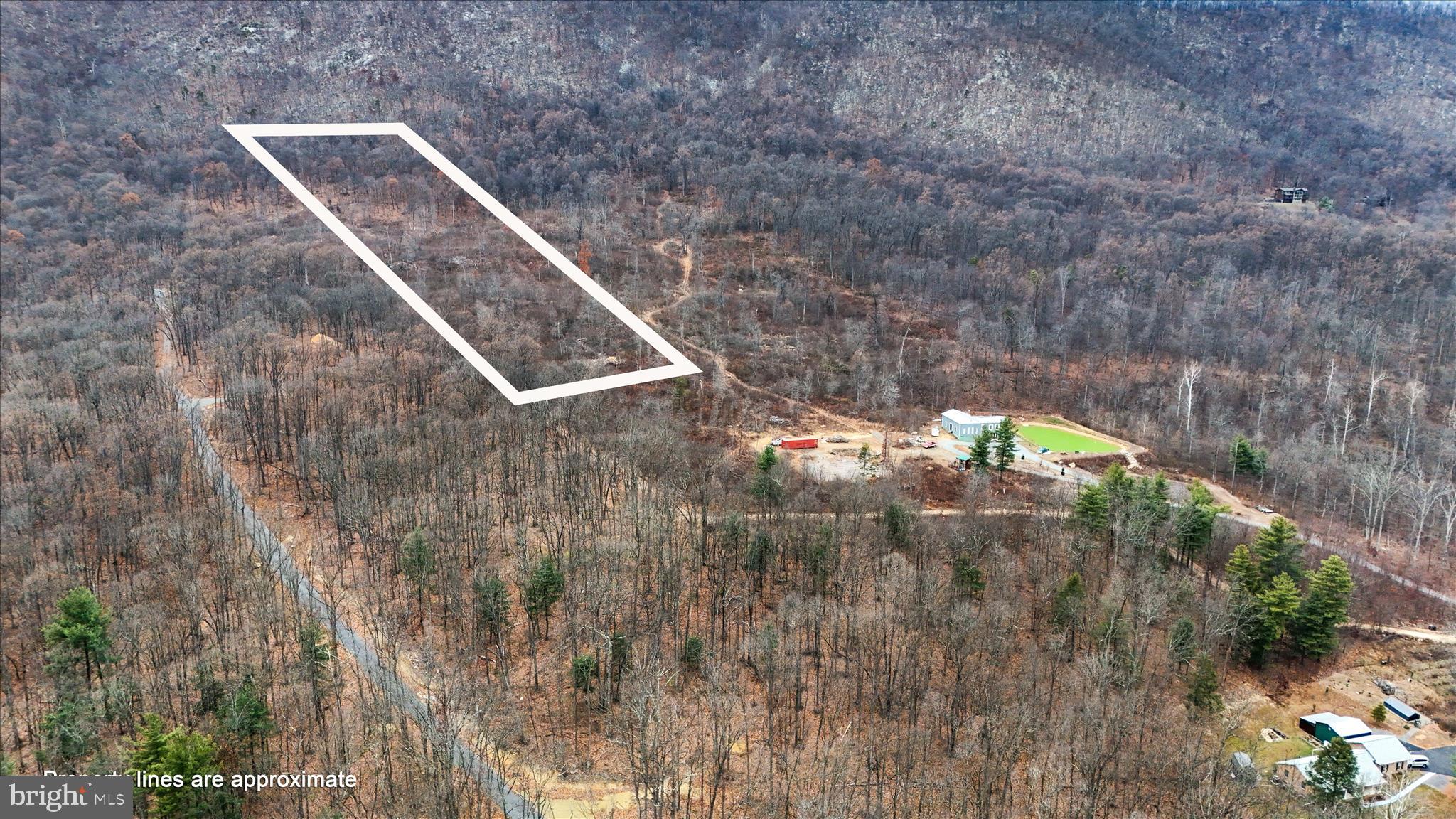 Welcome to Lot 5 on Bonaventure Way! This wooded lot backs directly to CACAPON STATE PARK, offering privacy, natural beauty, a stream and perk approved .  The lot is residential only (no Airbnbs) and includes a $300 road maintenance fee. Conveniently located just minutes from Berkeley Springs, known for its historic mineral springs, charming downtown, local shops, and year-round recreation. A perfect setting to build your dream home in one of West Virginia’s most beloved small towns! Adjoining lot 4 on Bonaventure Way. If you make an appointment the homeowner will show you around the property.