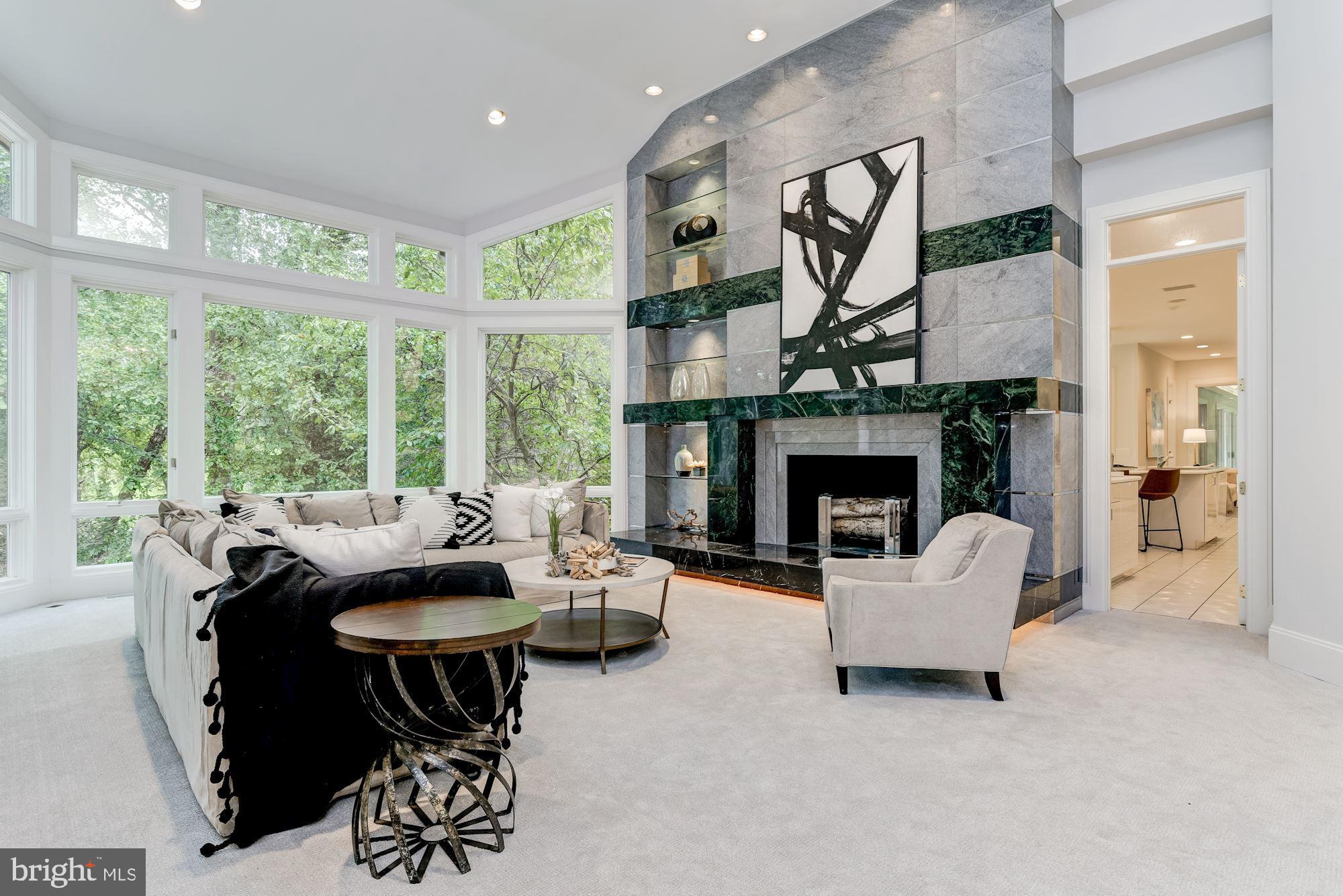 MOTIVATED SELLER for this "Home for All Seasons"!! Located in the heart of Potomac at the end of a quiet cul-de-sac on 2.41 acres, there is nearly 13,000 Sq.Ft. of finished space on three levels. Designed by Michael Ochsman, this modern masterpiece features a transitional floor plan with generous rooms, high ceilings, and loads of windows. The incredible Foyer welcomes you with its 15'+ ceiling and gleaming marble floors. The soaring ceiling continues from the Foyer into the Living Room where the floor-to-ceiling marble fireplace with raised hearth and built-ins complement the wall of windows that overlooks Falls Road Golf Course. A highlight of the first floor is a 49' indoor heated pool enclosed in a separate 62' X 27' structure adjacent to the informal Family Room and Kitchen. The Primary Bedroom Suite is on the Main Level and features multiple built-ins, 2 over-sized organized walk-in closets, and an En-Suite Bath.  There is plenty of space on the Upper Level with a Lounge surrounded by 5 Bedrooms, each with En-Suite Baths. The Walkout Lower Level provides opportunities for a variety of uses and includes an Exercise Room, a Recreation Room, a Powder Room, 2 Bedrooms, 2 Full Baths, and a Dark Room. Surrounded by lush mature landscaping, there is a Gazebo, multiple Patios, a Circular Driveway, and a 4-Car Side Entry Garage with large Courtyard. Ideally located close to Potomac Village, access to I-270 and I-495, Virginia, and downtown DC are in close proximity. Area residents can take advantage of the nationally rated Montgomery County School system as well as the area's three major airports.