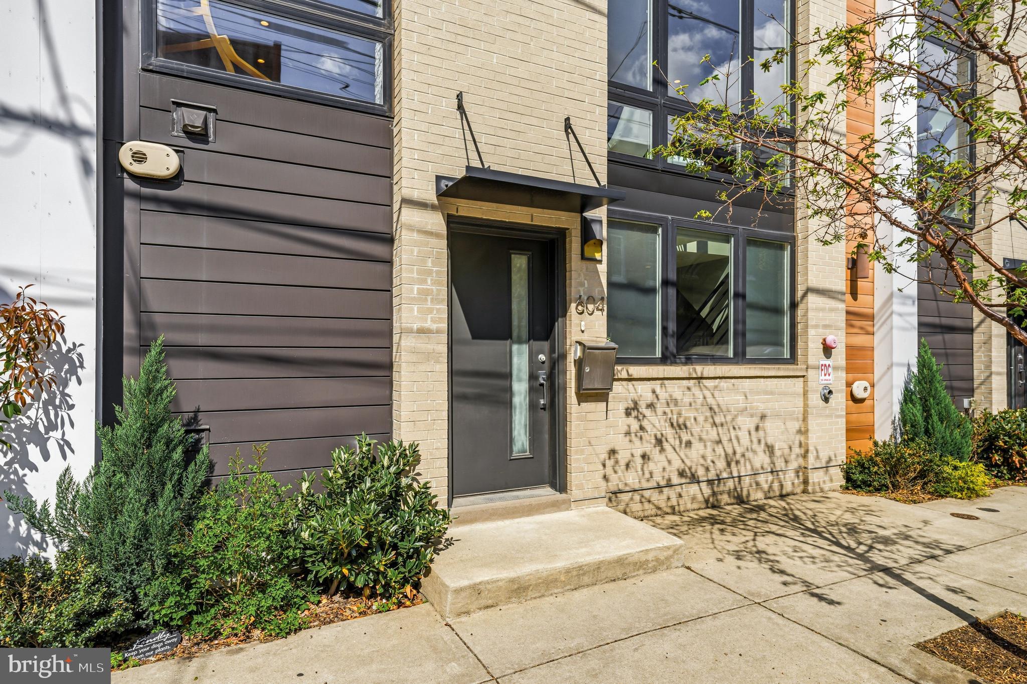 Welcome to 604 N 4th Street, a sophisticated four-story townhome tucked within a private gated community in the heart of Northern Liberties, where thoughtful design, intelligent technology, and effortless entertaining converge. A rare two-car attached garage anchors the entry level, joined by a gracious foyer, powder room, and coat closet.

The finished lower level delivers genuine flexibility: wall mirrors and a dedicated wellness space currently configured as a boutique home gym, with room to adapt as your needs evolve.

The main living level is built for both quiet evenings and full-house entertaining. A stone gas fireplace anchors the room, flanked by oversized Andersen windows with remote-controlled blinds. The kitchen doesn't compromise: Viking six-burner range with pot filler, Miele wall oven and steam oven, Bosch dishwasher, built-in wine refrigerator, quartz countertops, and a hammered metal farmhouse sink. A dining area flows into a built-in dry bar with dedicated storage, a layout that feels permanent and purposeful.

The second floor offers two generously scaled bedrooms, each with a private en suite bath, plus a full laundry room with additional storage conveniently on this level.

The entire third floor belongs to the primary suite. The custom walk-in closet is outfitted floor to ceiling. The spa bath features heated floors, a towel warmer, mirror defogger, double vanity, soaking tub, and glass-enclosed shower. A private wet bar with beverage fridge, sink, and cabinetry doubles as a morning coffee station and evening retreat, with access to a private balcony beyond.

Above it all, the roof deck delivers what Northern Liberties promises: panoramic 360° views of the Philadelphia skyline, a dedicated gas line for grilling, built-in outdoor speakers, and wired for television and internet, a fully finished outdoor room that sets this home apart from nearly everything in its class.

Throughout: Savant whole-home automation integrating lighting, AV, climate, garage, and security. Sonos multi-zone audio through built-in speakers throughout every level of the home and roof deck. Lutron smart switches and thermostats. Haiku ceiling fans in every bedroom, the wet bar, and living room. 5.1 surround sound in the living room. Level smart lock. Whole-home water filtration with reverse osmosis at the kitchen sink. Andersen windows throughout. Hardwood floors on every level.

Step outside and you're in the middle of Northern Liberties at its best. Café La Maude, North Third, Yards, and Bourbon & Branch within blocks, with seamless access to I-95, 676, and public transit.