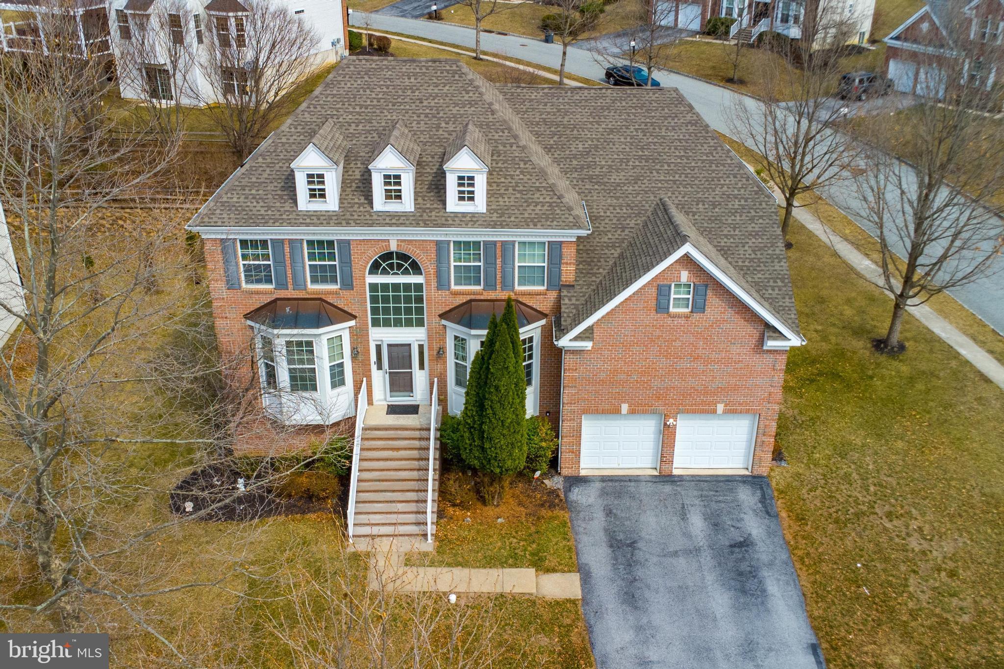 Elegant brick-front Colonial on a prime corner lot in the desirable Byers Station neighborhood!  Amenities include pool, pool house, playground, tennis and basketball courts.  Located in award winning Downingtown school district.  Enter into the soaring two-story foyer, where bay windows fill the space with sunlight and hardwood floors run throughout the space. The gourmet kitchen is drenched in natural light and boasts ample cabinetry, granite counters, stainless steel appliances, tile backsplash and a walk-in pantry.  Glass doors open to a spacious, low-maintenance deck—ideal for outdoor gatherings.

The expansivr family room offers radiant-heated wood floors, a stunning wall of windows, and gas fireplace. A first-floor bedroom with full bath is perfect for guests, an office or visiting grandparents. Upstairs, the primary suite features a tray ceiling, a sitting area, and walk-in closet with an expansive additional space with perfect for an upgraded closet space or home office.  The en-suite bath includes a large tiled shower, soaking tub, and dual vanities. Three additional bedrooms with hardwood floors share a beautifully updated hall bath.

The finished above grade, lower level includes large egress windows, a full bath, kitchenette, fitness space, office, pellet stove, and a 20x20 storage area. The oversized two-car garage is equipped with an epoxy floor, Tesla charger, and custom overhead storage.

Located in the highly rated Downingtown East school district with access to the STEM Academy, this home also features high ceilings, a tankless water heater, a water softener, and a newer HVAC system. Enjoy Byers Station’s resort-style amenities, including two clubhouses, pools, fitness centers, scenic trails, and courts for tennis, basketball, and volleyball. Prime location near the PA Turnpike, Route 30, and major highways!