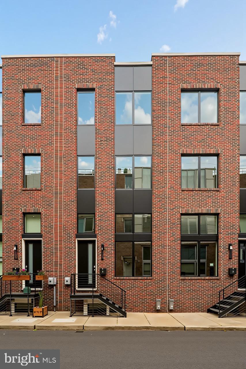 Welcome to Strata — a stunning new townhome development offering 1- and 2-car garage parking, ORIGINAL ten year tax abatement, and options to customize. These beautifully designed residences feature 3 bedrooms, 2 full bathrooms, and 2 half bathrooms, blending modern architecture with refined finishes to create the perfect balance of comfort and sophistication. 1342 S Woodstock Street is a highly desirable corner residence in the community, offering extra windows that fill the home with abundant natural light. This beautifully designed home features private one-car parking and a thoughtful layout that blends modern design with everyday functionality. The main living area impresses with its double-height ceilings and open-concept design, creating a bright and airy atmosphere perfect for both relaxing and entertaining. The living room flows effortlessly into a chef-inspired kitchen, complete with sleek slim-shaker cabinetry, quartz countertops, a spacious peninsula with barstool seating, and premium stainless steel GE Profile appliances—including a built-in microwave drawer and an exterior-vented hood. Buyers have the unique opportunity to personalize their home by selecting their own finishes. The adjacent dining area offers ample space for gatherings, highlighted by a dramatic glass wall that overlooks the living room below. Upstairs, the private primary suite spans its own level for ultimate comfort and tranquility. The spa-like bathroom, finished with elegant Porcelanosa tile, features a freestanding soaking tub, a large walk-in shower, double vanity, and private water closet, along with a generous walk-in closet. A conveniently located powder room on this floor is ideal for guest use. The upper level includes two additional bedrooms, a full bathroom, and a stylish dry bar—perfect for a morning coffee station or evening cocktail setup. Natural light from the pilot house brightens the entire stairwell and leads to the expansive rooftop deck, where you’ll enjoy breathtaking views of Center City, the Walt Whitman Bridge, and the nearby sports stadiums—making it the perfect setting for game days or hosting friends and family. Additional highlights include a full finished basement with high ceilings, ideal for a home office, gym, or flexible living space. Strata offers not only elevated living but also an exceptional location. Nestled in the desirable South Philadelphia area, residents are minutes from Passyunk Square’s vibrant restaurants and cafés, lively parks, and enjoy easy access to major highways and public transportation. Each home comes with a 10-year tax abatement and a 1-year builder’s warranty, providing peace of mind and exceptional value. Schedule your showing early to customize your finishes and make your dream home at Strata a reality. Taxes and square footage are the responsibility of the buyer to have verified independently. Renderings are for marketing purposes only and may not depict actual finishes.