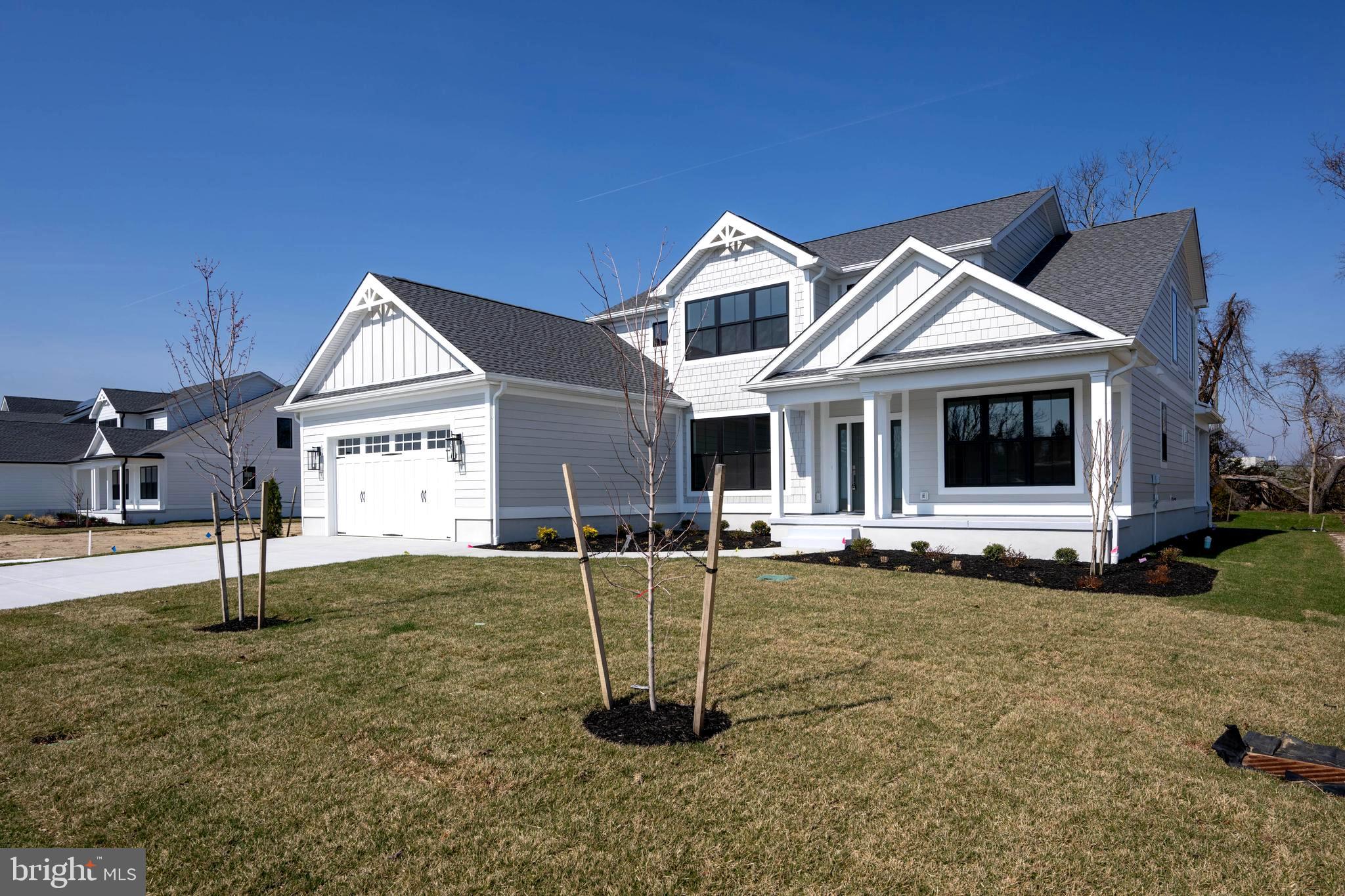 MOVE-IN READY! BRAND NEW COASTAL LUXURY IN THE HEART OF HISTORIC LEWES. Welcome to 169 Tyler's Circle—wake up and stroll to the Lewes Canal with your morning coffee. Entertain with ease.  Live beautifully—every single day.  In the heart of Lewes, in the sought-after community of Fishers Cove, this newly constructed contemporary coastal home delivers the lifestyle buyers are searching for, space to gather, room to retreat, and a location that keeps you close to everything.  Premier in-town Lewes setting.  Minutes to downtown shops, dining, and beaches.  Established charm with the benefit of brand-new construction.  Enjoy the convenience of being close to it all—without sacrificing privacy or comfort.  5 Bedrooms | 4.5 Baths | Thoughtful, Flexible Floor Plan.  This home was built with today’s buyer in mind: Open-concept main living area perfect for entertaining and everyday living.  Chef’s kitchen with high-end appliances, granite countertops & oversized island.  Walk-in pantry with prep space for seamless hosting.  Separate dining room for gatherings both formal and casual.  Vaulted great room with expansive windows & custom fireplace wall.  Whether it’s a quiet evening at home or a full house of guests, the layout adapts effortlessly. MAIN-LEVEL CONVENIENCE.   Private primary suite with spa-inspired bath & walk-in closet.  First-floor en-suite bedroom—ideal for guests, multi-generational living, or a home office Mudroom & laundry area off the 2-car garage with extra storage. Everything you need—right where you want it. Upstairs you’ll find two guest bedrooms with a beautifully appointed shared bath A fifth bedroom featuring an oversized en-suite bath.  Room to spread out. Room to host. Room to grow.  INDOOR-OUTDOOR COASTAL LIVING.  Inviting front and rear porches.  Landscaped yard.  Perfect settings for morning coffee or evening gatherings.  Quality finishes throughout include engineered wood and luxury vinyl plank flooring—designed for both style and durability.  The Bottom Line.  This is more than new construction. It’s the rare combination of location, design, and everyday comfort—all in one of Lewes’ premier in-town communities.  Fishers Cove is where your next chapter begins.