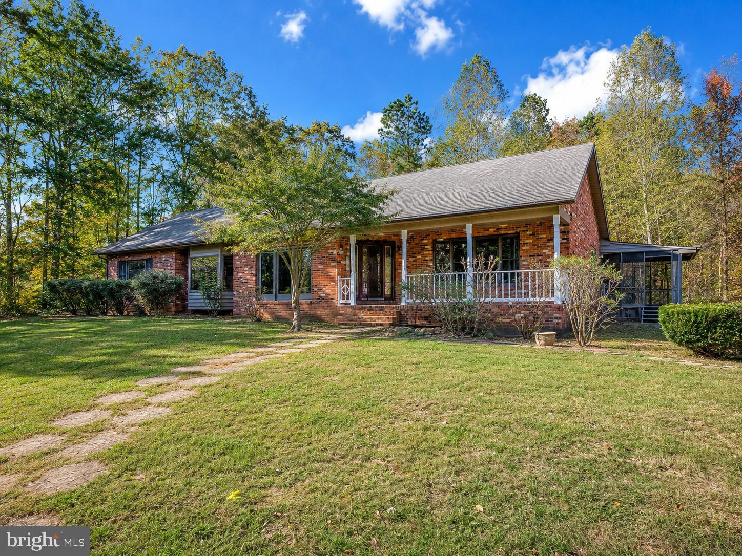 7 ACRES. FULL BRICK. PRIME SPOTSYLVANIA LOCATION.
6709 Marye Road sits on nearly 7 ACRES in Spotsylvania County and offers a FULL BRICK ranch with 3 bedrooms, 3 full baths, and considerably more living space than the bedroom count suggests.
The main level includes three generously sized bedrooms, two full baths, a formal dining room, and a family room. The standout space is a large bonus room with four skylights, a ceiling fan, and French doors opening to views of the wooded rear yard. Bright, open, and flexible, this room can serve a wide range of needs. A separate main-level room currently serves as a workshop, with its own French door to the rear yard and good natural light, making it a great option for a home office, studio, hobby room, or additional flex space.
The FINISHED WALKOUT LOWER LEVEL adds a third full bath and flexible space for recreation, guests, hobbies, storage, or future use. With 11 SKYLIGHTS throughout the home, the interior feels brighter than many homes of this size and setting.
Important updates have already been made, including RECENT KITCHEN AND BATH REMODELING, a NEW 2-ZONE AIR CONDITIONING SYSTEM, and a septic system that has been inspected, repaired and pumped. The home is comfortable and ready to use now, while still giving the next owner room to make additional improvements over time and further elevate the property.
The location is a genuine asset. Kalahari Resorts, planned as a 900-room hotel with a 260,000-square-foot indoor water park and convention center, is approximately 5 MINUTES AWAY. I-95 access and Dominion Raceway are about 10 MINUTES AWAY. With Kalahari, Dominion Raceway, and the Thornburg/I-95 corridor continuing to attract attention and investment, this is an area already on a clear development trajectory.
This is a COUNTRY PROPERTY WITH ACREAGE, not a subdivision home. Access is by a shared driveway with a right of the way agreement in place. For buyers who want land, space, a well-built brick home, and a location near major growth without paying for someone else’s full renovation, 6709 Marye Road offers a rare combination.