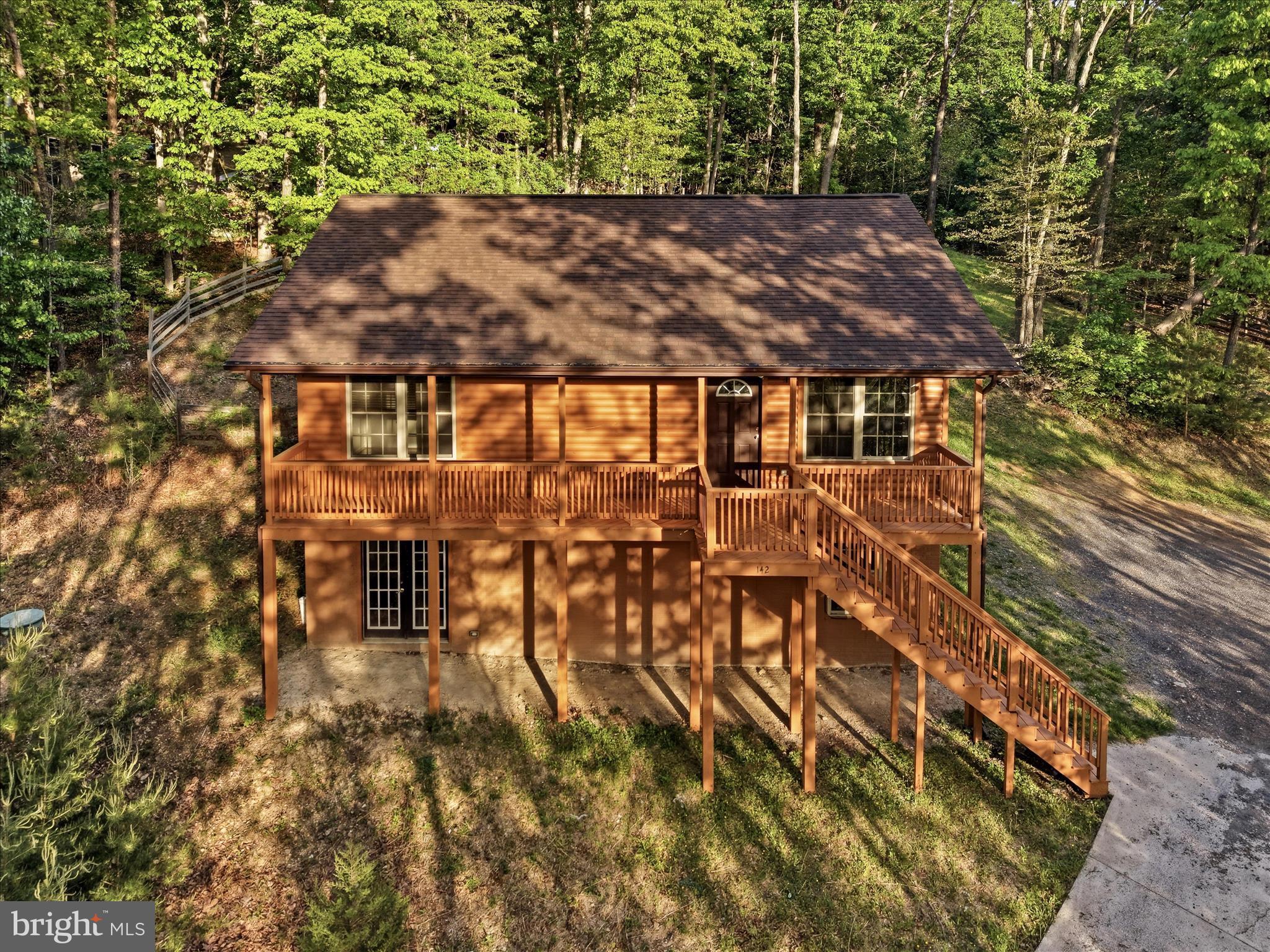 Do you need a home that feels like a retreat away from the hustles of city life? Have you ever thought you could/should spend more time on the amazing Shenandoah River? 

Well, you can stop the search. Welcome to 142 Spring Hollow Rd in Shenandoah Farms! The home welcomes you with an exciting country appeal including a large front porch, large rear deck, and plenty of area around the basement entrance. The views will speak for themselves.  Minutes from river access, the inside of the home will amaze you..

On the main floor when you walk in the front door, you are welcomed with an open layout, perfect for hosting. Two spacious bedrooms with two full bathrooms upstairs will be just right. This floor has the country touch hardwood floors. Next, as you walk downstairs, you will see there is plenty of space in the home. The ground level has a full bedroom with a full bathroom plus plenty of room for an additional living room space or even a large open bedroom accommodation.  The carpet adds the warmth for cool evening and the winter hideaway. 

The home has gutter guards for low maintenance. The driveway is less than 3 years old and carries a warranty plus the septic system is upgraded and highly reliable. The exterior of the home has recently been painted with a durable exterior paint to help with low upkeep expenses. 

The home is ready for a loving buyer!