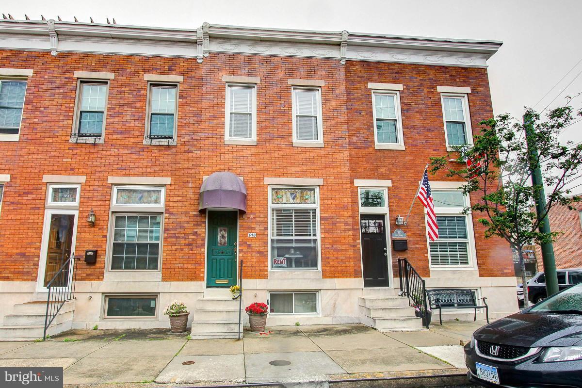 Oozes charm, hardwood floors, designer touches throughout. Beautifully remodeled eat in kitchen, dining room, sunny living room. Powder/laundry rm.  9 ft ceilings. Master bedroom w/ sep sitting room, 2nd bedroom, gorgeous upstairs bath. Parking space off street. Great location historic Locust Point near restaurants, shopping. Available July 1. No Smokers. Pets on Case by Case Basis. Sec Dep $2,300