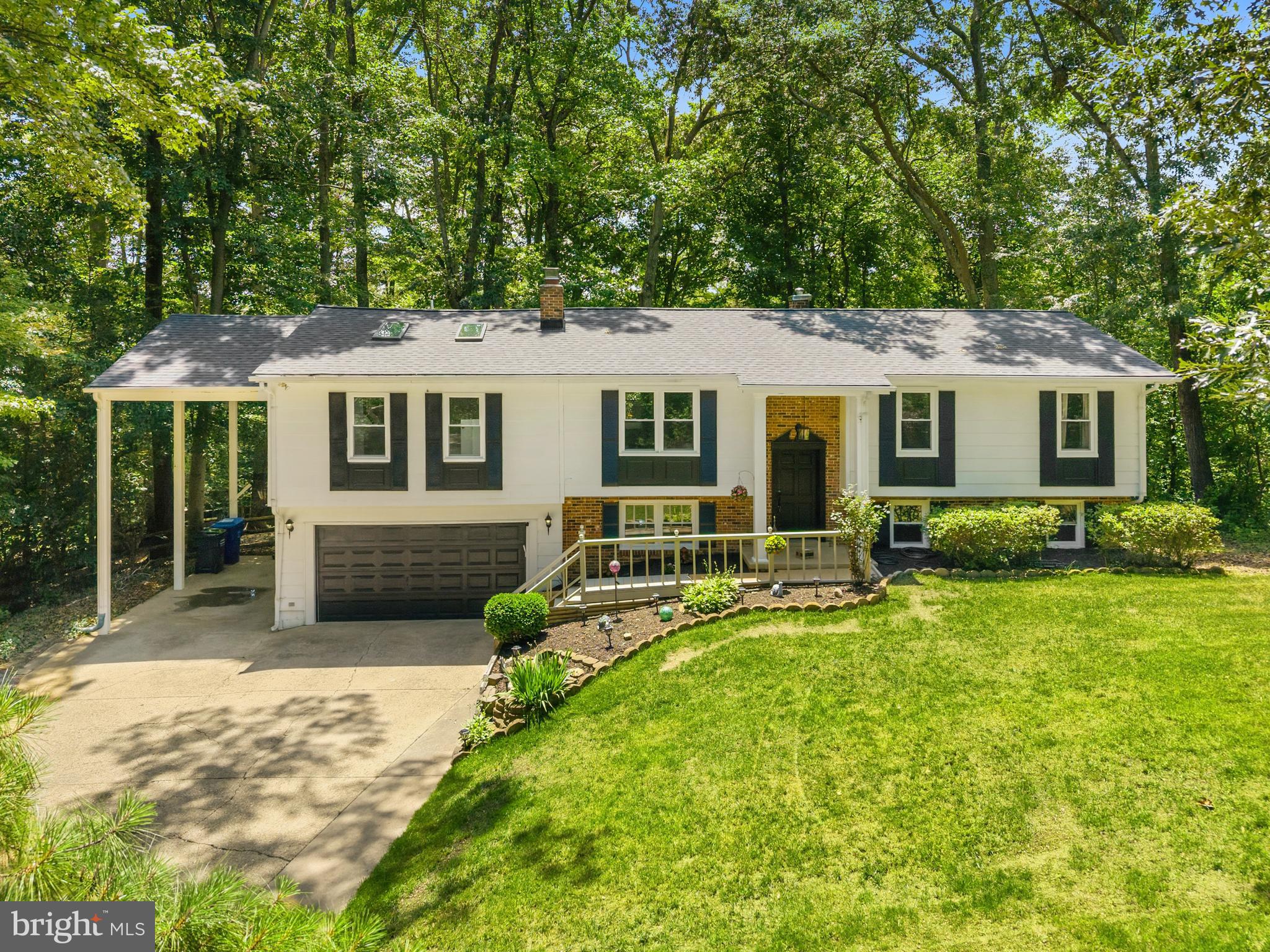 Spacious and beautifully updated, this 5-bedroom, 4-bath home offers exceptional living space inside and out. Brand new roof (June 2026) and HVAC (2025)! The renovated kitchen features a center island, ample cabinetry, and an open feel ideal for everyday living and entertaining. The impressive primary suite includes skylights, a walk-in closet, and a spa-inspired bath with a large shower and dual shower heads. Updated bathrooms throughout add modern appeal. The lower level boasts a cozy living room with a fireplace, creating the perfect gathering space. Enjoy outdoor living on the deck or back patio overlooking a fenced backyard lined with mature trees for added privacy. A storage shed provides extra space, while the garage, carport, and driveway offer abundant parking options.