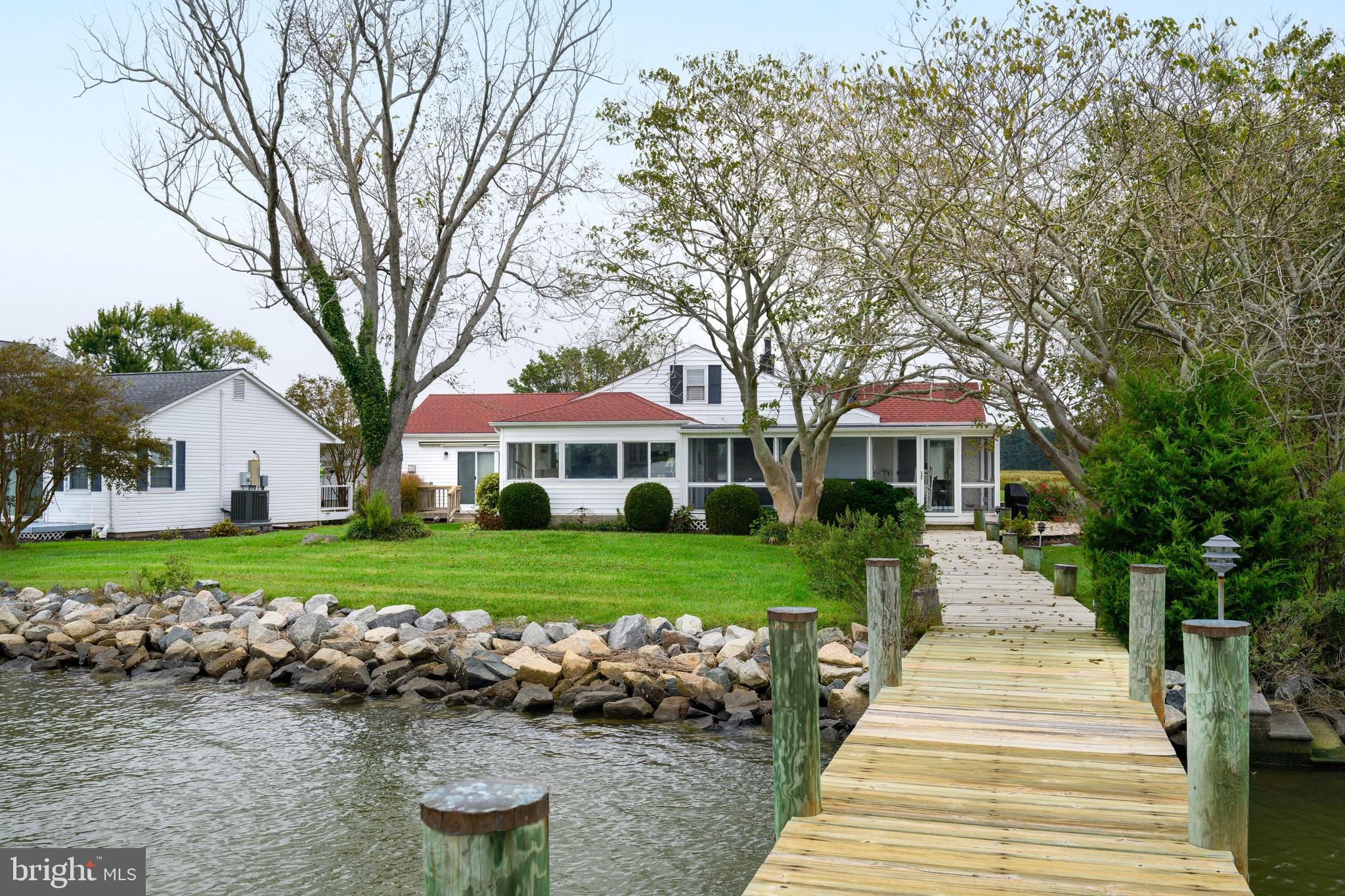 Improved Pricing! Was $875,000 now $849,500.   Major Interior Renovations completed in 2022 (see attachment for full list). This beautifully updated and meticulously maintained, 3-bedroom, 2-bath home offers over 2,300 square feet of bright living space designed to capture the beauty of waterfront living. Panoramic water views greet you from nearly every room, with the living room highlighting breathtaking vistas of Fishing Creek. Two spacious living areas, each with a cozy fireplace, make relaxing or entertaining effortless year-round. The open gourmet kitchen features custom finishes, modern updates, and a built-in wine cooler—perfect for gathering with family and friends. The primary suite includes a private bath, while the open floor plan provides both functionality and seamless flow.
 
Major systems have already been taken care of for you—roof replaced in 2018, HVAC replaced in 2022, and new thermostats installed in 2024—so you can move in with confidence. A new sprinkler system, plus all French gutter drains installed in 2025 and an improved Dry-Zone encapsulated crawl space further enhance efficiency and long-term protection. For added reassurance, the home includes transferable flood insurance and annual Dry-Zone, HVAC and pest control inspection contracts. Home is connected to public sewer, helping to simplify ownership from day one.
 
Ideally located just a short distance from historic Cambridge, the Hyatt Regency Chesapeake Bay Golf Resort, and within easy reach of Easton, Oxford, and St. Michaels, you’ll also enjoy close proximity to Blackwater Wildlife Refuge—perfect for exploring nature, spotting eagles’ nests, or enjoying canoeing, biking, and hiking trails.