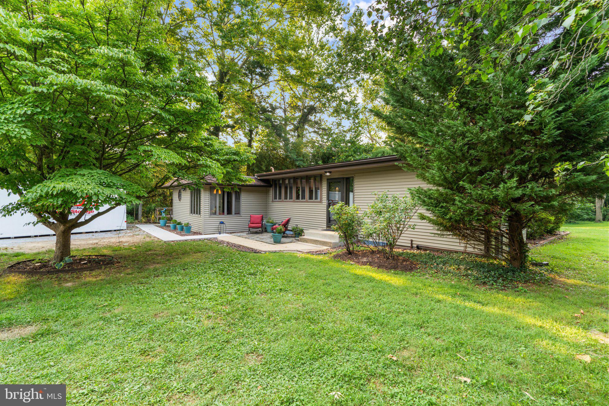 Welcome to 716 Andover Road, where privacy, comfort, and thoughtful updates come together on an exceptional 1.41-acre lot in the heart of Linthicum Heights. This lovely three-bedroom, two full-bath rancher offers the ease of one-level living surrounded by mature trees and peaceful outdoor space.
A circular driveway provides great functionality and plenty of parking. Inside, you’ll find hardwood floors throughout, a warm and inviting fireplace, and an updated kitchen featuring granite countertops, stainless steel appliances, a brand-new dishwasher and cherry cabinets.
The spacious primary bedroom is complete with a walk-in closet and a luxurious en-suite bath featuring heated floors and a relaxing Jacuzzi tub.
Major improvements provide added peace of mind, including new windows, siding, and a sliding glass door (2017), brand-new flat roof (2024), and a professionally installed new waterproofing system with French drain, dual sump pumps, and a transferable warranty (2026). Additional exterior enhancements include a new front walkway and front steps.
If you’ve been searching for a home that offers exceptional privacy, modern updates, and a rare 1.41-acre setting while remaining convenient to shopping, dining, commuter routes, BWI Airport, Baltimore, Annapolis, and Washington, D.C., this is an opportunity you won’t want to miss.
