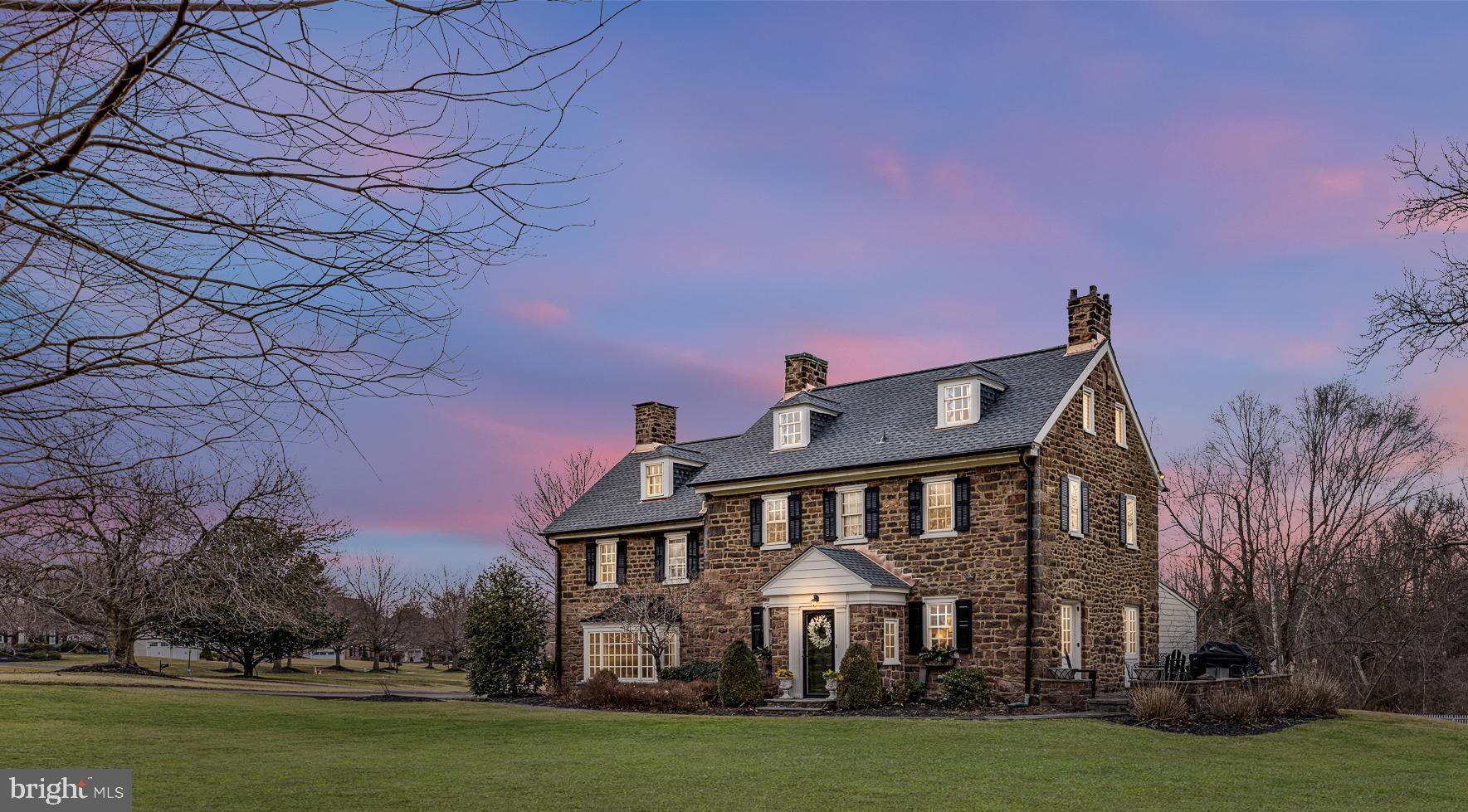 Welcome to historic Lakeview Farm located in Maple Glen. True to its name, the home is nestled on over two acres of beautiful landscapes, an abundance of natural light and overlooks a serene lake. The improvements done over the years have stayed true to the time period of the hallmark construction from the wide beam hardwood floors to the two-zoned central air conditioning. It is evident throughout the home, especially in the kitchen, adorning soapstone countertops, Sub-Zero refrigerator, Heartland stove and oven, and Fisher-Paykel dishwasher; all beautifully complimented by the custom cabinetry. The wet bar area in the kitchen has a handsome copper sink and wine refrigerator. The opulent living room has a fireplace and window with sweeping landscape views fit for Claude Monet. The dining room is perfect for any large feast complete with a walk-in cooking fireplace. There is a home office on the main floor complemented with built-in shelves and unique Prohibition Bar!  The mudroom and laundry are conveniently located on the main floor along with a powder room. Follow the red oak stairs to the owner's suite which includes a dressing room, comfortably accommodates king size bed, and private bathroom with heated floors, a clawfoot tub, keeping in touch with the style of the home. The second bedroom has a full private bathroom with a tub and shower. On the third floor there are two additional bedrooms along with another full bathroom perfect for out of town guests or family to have their own space. Beyond the majestic views, there is a four car garage and bonus room with a bar and its own bathroom. Perfect for another home office, home gym or studio for painting, the opportunities are endless and yours to enjoy. The spring house has a well which is used solely for the outdoor sprinkler system.  You absolutely can have an authentic farmhouse while still having all of the modern conveniences at your fingertips.