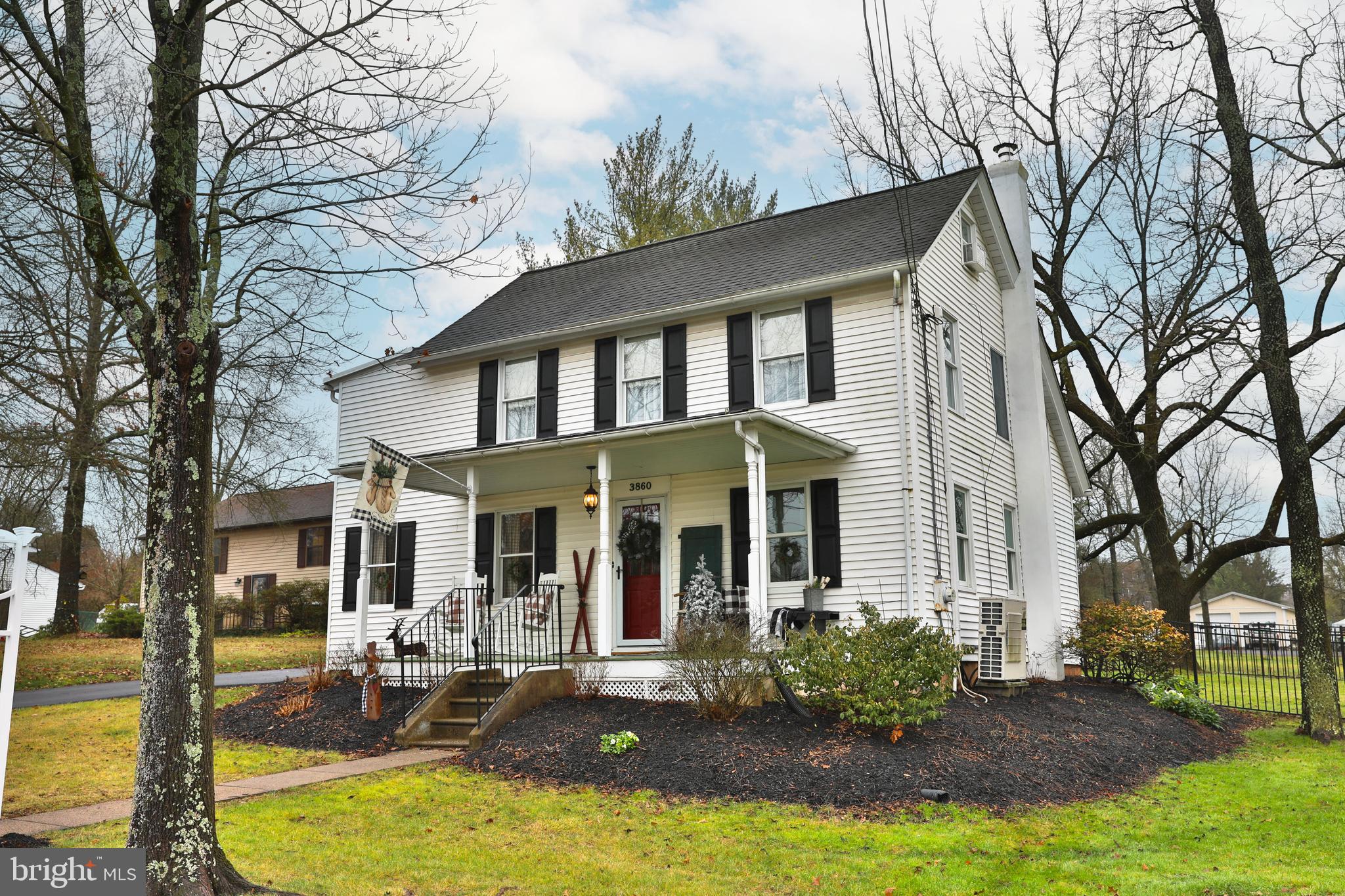 Nestled on a serene country street, this quintessential, timeless late 19th-century farmhouse offers a perfect blend of old world charm and modern amenities. Located on a large corner lot,  this lovely property is with-in a short walk to Hallman Grove, a sprawling  21-acre nature preserve, and the vibrant Skippack Village main street. Discover the trove of quaint shops, restaurants, bars and coffee shops while engaging in lively annual parades and festivals. Many of the original architectural details such as, pine floors, bead board paneling, beamed ceiling, wide baseboard and distinctive hardware were preserved. The charming décor, curated by the owner, compliments the resident's  character--a collection that could potentially remain ( not in its entirety ) for the buyer.  Entertain effortlessly in the formal dining room, accommodating sizable dinner parties, or have a more intimate gathering in the cozy living room.  The country kitchen features granite counters, ceramic tile back splash,  stainless steel appliances, and a bright spacious table area framed by a large picture window . The spacious laundry/mud room and the second full bathroom are conveniently located on the main level. Upstairs, you will find the main bedroom with beamed ceiling and a charming barn door entrance to a versatile space ideal for an office space, nursery, or expanded closet. A fitted walk-in closet is located by the main bedroom. Completing the second floor are a second bedroom, generous size hall bathroom and 2 hall closets. The Finished attic present an additional flexible space suitable for an office, play room or guest area.  A lovely front porch, a side patio and fenced-in back yard  are great features enhancing the outdoor use of the property,   New oil tank, new chimney liner, new sump pump with back-up batteries, driveway newly re-surfaced and gutter guards newly installed.  Easy to show, bring all buyers who want a special home but do not need it to be big.