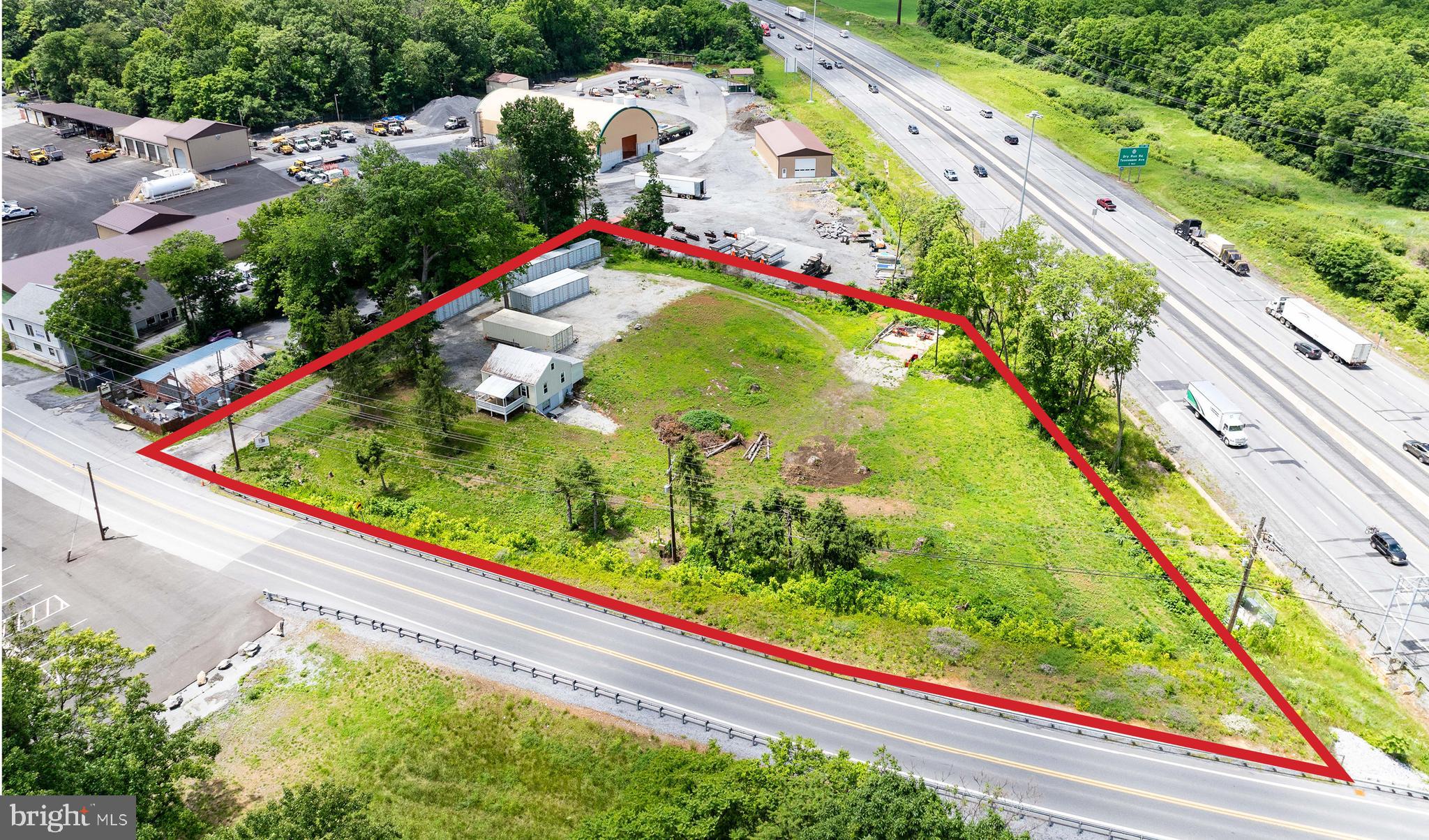 1.67 acres with public water, sewer.  Fronts on Interstate 81 and Rock Cliff Dr., Berkeley County Planning Comm. approved for 42 storage units (Currently 5 units in place) and 10 RV pad sites. Signage visible to Interstate 81.   2 Bedroom,  2 bath rental house with full basement, wood and ceramic flooring, new central air, updated wiring and vinyl siding.