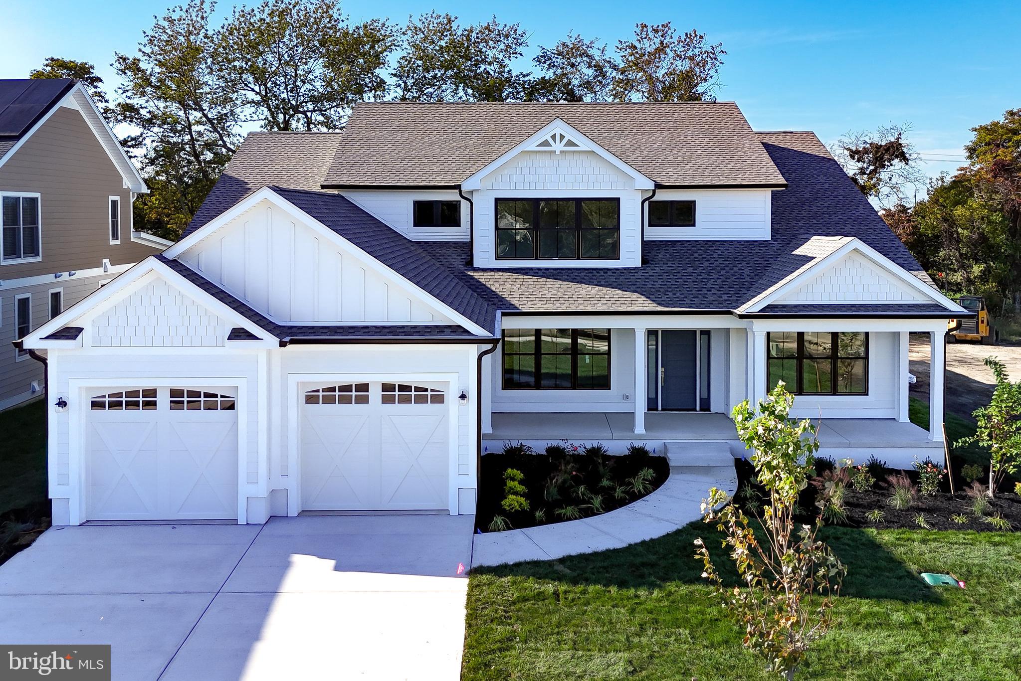 MOVE-IN READY! BRAND NEW COASTAL LUXURY IN THE HEART OF HISTORIC LEWES. Welcome to 165 Tyler's Circle—wake up and stroll to the Lewes Canal with your morning coffee. Entertain with ease.  Live beautifully—every single day. In the heart of Lewes, in the sought-after community of Fishers Cove, this newly constructed contemporary coastal home delivers the lifestyle buyers are searching for, space to gather, room to retreat, and a location that keeps you close to everything.  Premier in-town Lewes setting.  Minutes to downtown shops, dining, and beaches.  Established charm with the benefit of brand-new construction.  Enjoy the convenience of being close to it all—without sacrificing privacy or comfort.  5 Bedrooms | 4.5 Baths | Thoughtful, Flexible Floor Plan.  This home was built with today’s buyer in mind: Open-concept main living area perfect for entertaining and everyday living.  Chef’s kitchen with high-end appliances, granite countertops & oversized island.  Walk-in pantry with prep space for seamless hosting.  Separate dining room for gatherings both formal and casual.  Vaulted great room with expansive windows & custom fireplace wall.  Whether it’s a quiet evening at home or a full house of guests, the layout adapts effortlessly. MAIN-LEVEL CONVENIENCE.   Private primary suite with spa-inspired bath & walk-in closet.  First-floor en-suite bedroom—ideal for guests, multi-generational living, or a home office Mudroom & laundry area off the 2-car garage with extra storage. Everything you need—right where you want it. Upstairs you’ll find two guest bedrooms with a beautifully appointed shared bath A fifth bedroom featuring an oversized en-suite bath.  Room to spread out. Room to host. Room to grow.  INDOOR-OUTDOOR COASTAL LIVING.  Inviting front and rear porches.  Landscaped yard.  Perfect settings for morning coffee or evening gatherings.  Quality finishes throughout include engineered wood and luxury vinyl plank flooring—designed for both style and durability.  The Bottom Line.  This is more than new construction. It’s the rare combination of location, design, and everyday comfort—all in one of Lewes’ premier in-town communities.  Fishers Cove is where your next chapter begins.