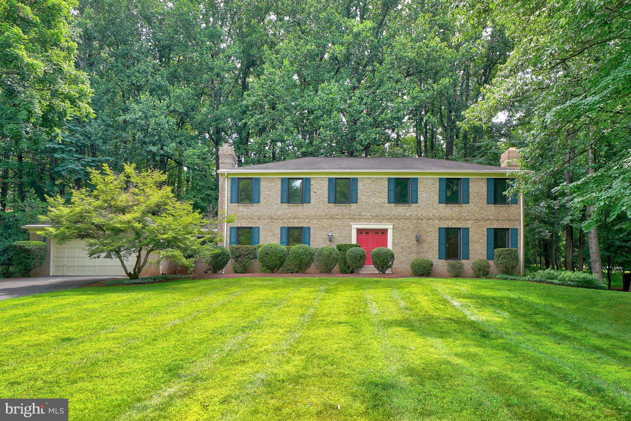 Nestled on a beautifully landscaped wooded corner lot of just under one acre, this spacious and timeless residence offers approximately 5,100 square feet of living space across three finished levels. Featuring five bedrooms, three full baths, and one half bath, the home combines classic craftsmanship with an exceptional setting in one of Potomac's most desirable neighborhoods.

Solid wood flooring flows throughout the home, complementing the generously sized formal and casual living spaces. The main level features an elegant living room with a fireplace, a formal dining room ideal for entertaining, and an inviting family room with a second fireplace. A richly appointed wood-paneled office provides the perfect work-from-home retreat.

The heart of the home is the kitchen, which offers direct access to both the deck and patio, creating a seamless connection between indoor and outdoor living. Surrounded by mature trees and lush landscaping, the private backyard provides a peaceful setting for entertaining, relaxing, or enjoying nature year-round.

Additional highlights include a convenient main-level laundry and mudroom, a two-car garage, and a spacious full basement offering abundant storage and flexible living space possibilities.

Combining generous room sizes, classic architectural details, and a spectacular wooded setting, 11701 Beekman Place presents a rare opportunity to enjoy gracious living in the heart of Potomac.