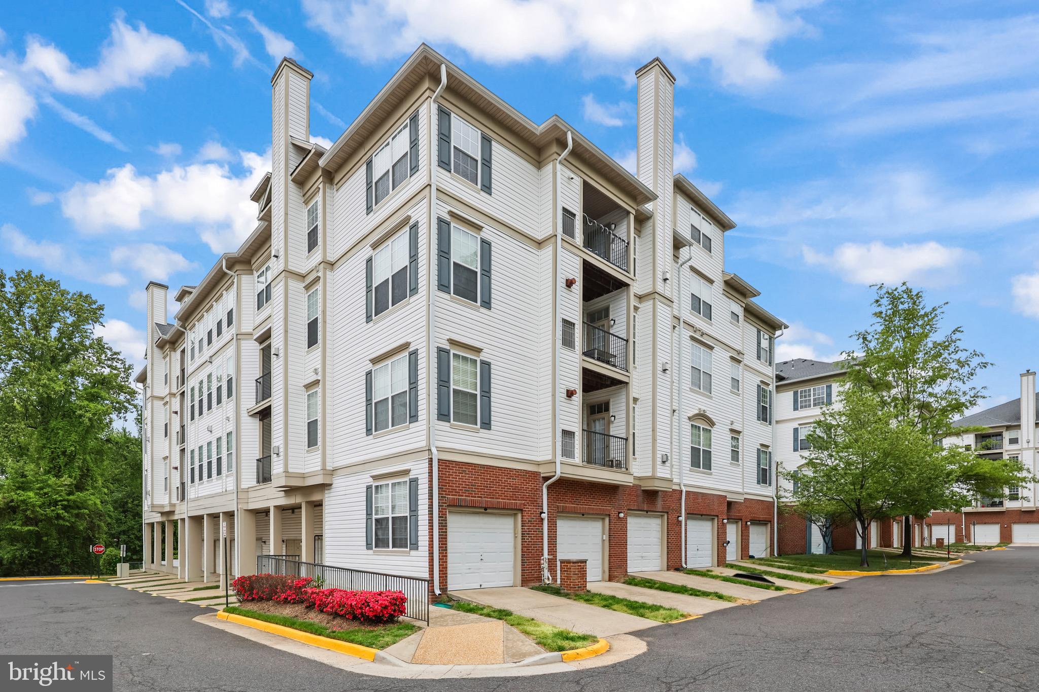 You’re going to love this move-in ready 4BR/3BA condo — it feels more like a single-family home. With 1,760 sq ft across a dramatic two-level layout and cathedral ceilings, the space is bright and airy thanks to large windows and an open, functional floor plan. Imagine cooking at the large island with quartz counters while still being part of conversation in the living room, which has a cozy fireplace and a balcony. The main living areas have elegant engineered flooring, and two guest bedrooms are carpeted for comfort. The kitchen was thoughtfully renovated with full-height cabinets, a custom backsplash, and all-new appliances. The primary suite is a real retreat: a custom bathroom with a walk-in shower, designer tile, water jets, linen cabinet and quartz counters. All toilets are new chair-height and every light fixture was recently replaced. The whole place is freshly painted in Benjamin Moore Metropolitan Grey. Practical perks you’ll appreciate: in-unit stacked washer/dryer, a new hot water heater, recessed lighting, on-site trash/recycling, and an oversized individual garage with its own driveway for extra storage and parking. The building is on the 4th floor with elevator access and also features a separate, easily accessible entrance designed for wheelchair access. Outside your door you can walk to the community pool, clubhouse with exercise room, tennis courts, tot lots and trails — and you’re just minutes from Wegmans, Costco, major shopping, and commuter routes like I-66, Routes 50 and 29 and Fairfax City Parkway. This is rare square footage in today’s market — if you want a bright, thoughtfully updated home that combines convenience and comfort, this could be the one.