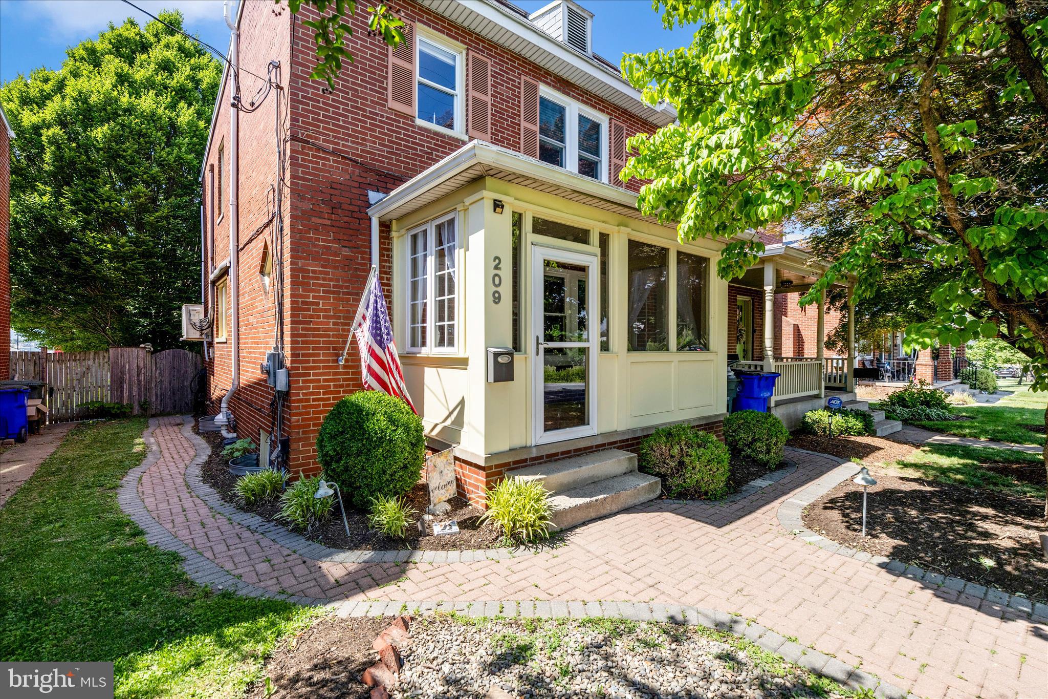 Welcome to this charming downtown duplex, perfectly situated in a vibrant, walkable community just steps from shops, dining, and local events. Blending classic character with modern updates, this move-in ready home features brand new windows, warm hardwood floors, and a bright enclosed front porch—perfect for year-round enjoyment. The main level offers a seamless flow from the living and dining areas to a cozy rear den with access to a spacious, fully fenced backyard. Outside, enjoy two large sheds with electricity—ideal for a studio, workshop, or extra storage—plus convenient off-street parking. The updated kitchen includes stainless steel appliances and stylish finishes, while the finished lower level provides additional living space and a generous laundry/utility area. Upstairs, you’ll find three bedrooms, a full bath, and a versatile bonus room. The primary bedroom features a custom closet organizer for added functionality. With beautiful  landscaping and great curb appeal, this home offers the perfect mix of location, charm, and convenience—don’t miss it!