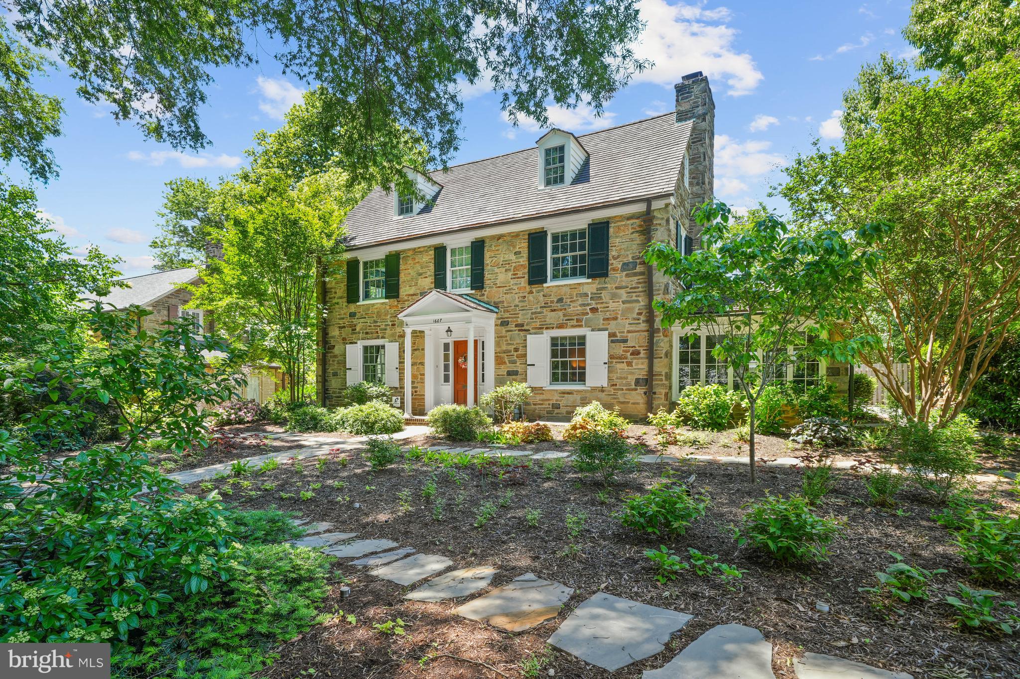 Welcome to 1607 North Bancroft Parkway! Situated in the Highlands, on the beautiful newly landscaped large corner lot, this stone colonial home is the perfect place to call home. The flagstone walkway wraps around the home leading to the back terrace. Enter the foyer which is flanked by the formal living and dining rooms. The living room features a wood burning fireplace complete with marble surround and mantel. Off of the living room is a sunroom clad in stone and windows on three sides. The sunroom (currently being used as an office) also leads to the side yard and woodshed. The dining room features a stunning crystal chandelier that is truly a work of art! Continue through the foyer to the renovated open floor plan gourmet kitchen and family room. Off the kitchen is a butler's pantry with a built-in corner cabinet with glass doors as well as extra closet space. The gourmet eat-in kitchen features a stainless steel Wolf 6 burner gas range with double oven. The white subway tile backsplash set off by stone countertops. The raised island with second sink provides additional storage and seating for three. Open to the kitchen is the large family room that provides access to the fenced in backyard. Expand your living and outdoor space on the terrace. Eat under the pergola, sit by the fountain or lounge on the terrace. The backyard is professionally landscaped and features extensive hardscaping and is perfect for entertaining family and friends. Host all of your events in the comfort of your own backyard retreat.  A half bath completes the first level. The upper level consists of the primary bedroom complete with 2 walk-in closets and a renovated Jack and Jill bathroom leading to the second bedroom. The second bedroom can be used as an office, den or a dressing room. The remaining 2 bedrooms also feature ample closet space and another Jack and Jill bathroom. The fifth bedroom is located on the third level. The bedroom is very large and includes a full newer bathroom and large sitting area. There are also two walk-in cedar closets. The basement with outside access has been updated with a water proofing system, built-in dehumidifier, French drain and a second sump pump. All of the windows and Bilco door was also replaced. Other updates include re-landscaped front yard and new sidewalks (2025), new zone 2 air conditioner (2024), gutter guards (2024) and a new hot water heater (2023). This home is perfect blend of classic style (hardwood flooring and crown molding throughout) and modern living. No detail has been overlooked, this home has been meticulously cared for and is turn key. We invite you to tour this home today!