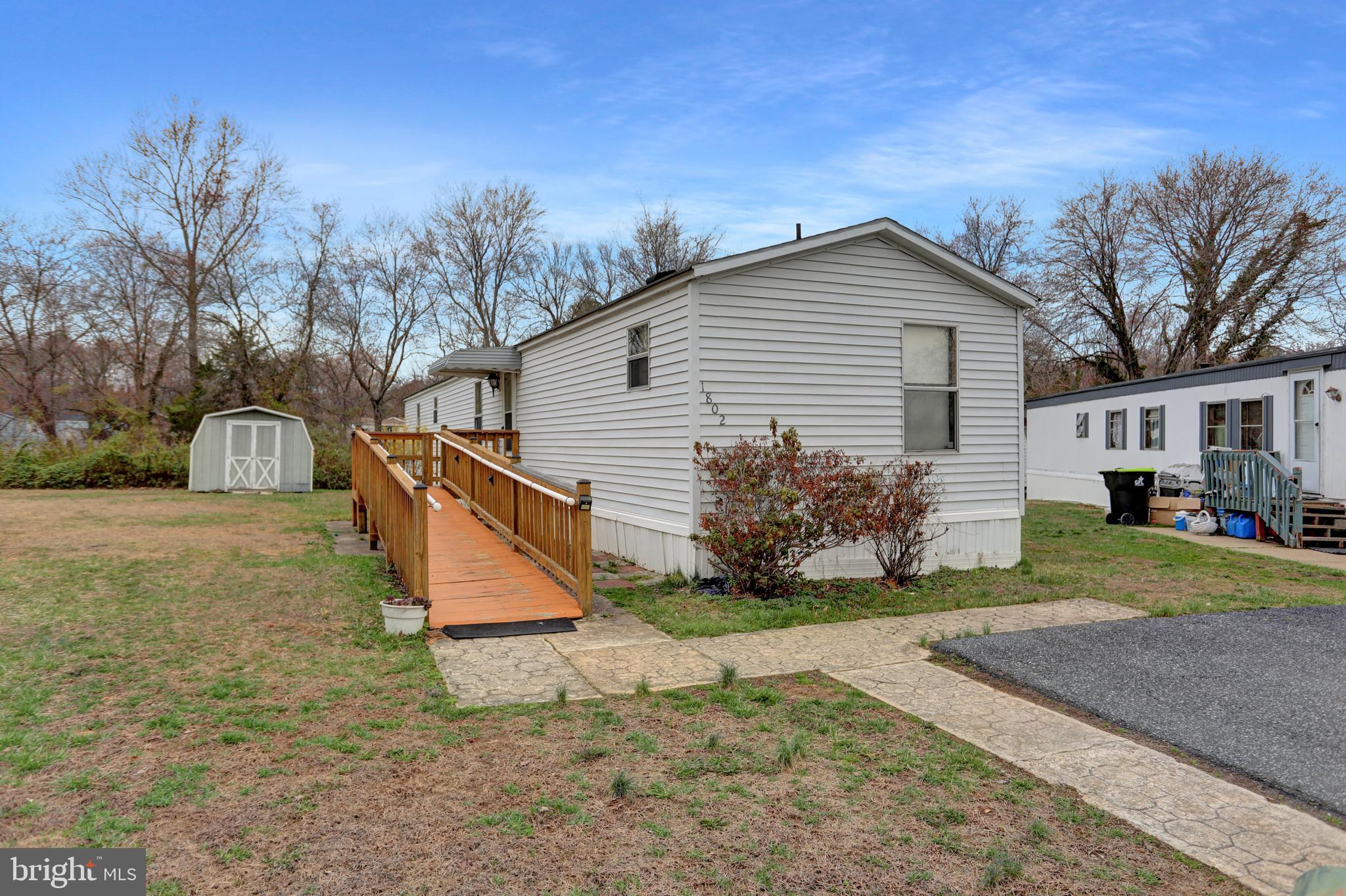 This 3 bedroom, 2 bath unit sits on a cul-de-sac and backs to woods and stream.   Spacious living room boast cathedral ceiling with decorative center beam,  separate Dining Room offers pass through window to Living Room and a large kitchen with lots of cabinets and a pantry.  The primary bedroom offers an en-suite and walk-in closet.  Washer and dryer located off the kitchen as well as the back door.     Has parking for 2 vehicles.  Great opportunity to get in but it needs some TLC.   Seller will not make any repairs.   STRICTLY AS-IS.   Buyer MUST get park approved.  Park will require buyer to be Owner Occupied (unit can not be rented out) Park Rent currently  $689/month plus water & sewer (personal usage will determine cost)