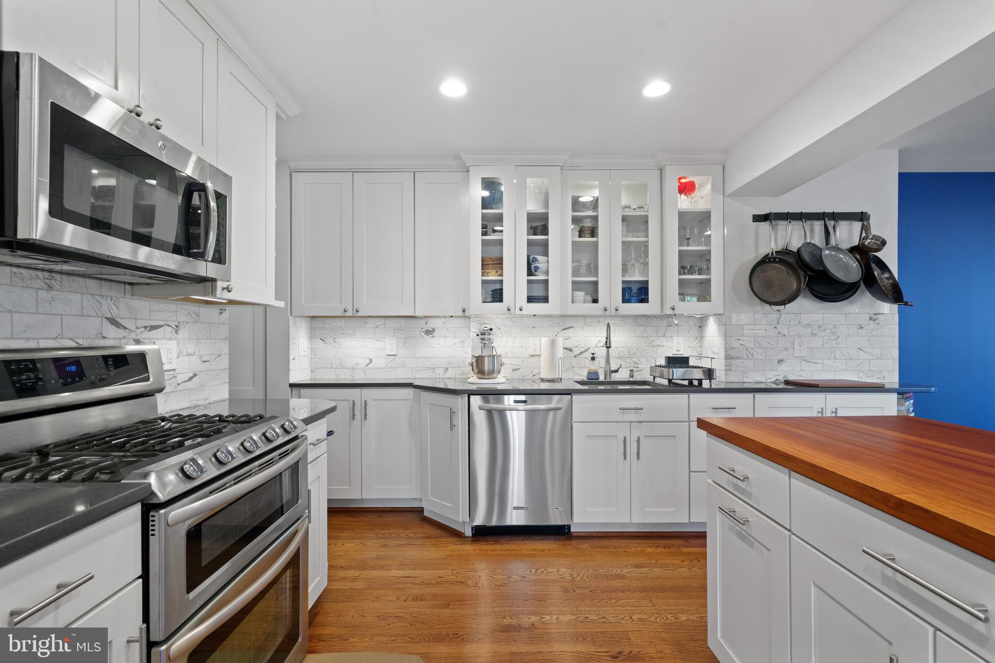 This charming 3-bedroom, 2-bath home in south Arlington offers a unique blend of comfort, convenience, and natural beauty. Unlike most homes in the neighborhood, this one features a stunning remodeled kitchen and a spacious living/dining room addition—perfect for entertaining. The layout includes two bright bedrooms upstairs with a full bath, while the sunny basement-level bedroom has its own full bath. The front room, currently a cozy family room, doubles as an office with built-in shelves, a TV closet, and a gorgeous bay window overlooking a park with a creek. There are storage shelves in basement utility room, external storage in crawl space, and more storage in the attic! The fenced backyard boasts a lovely patio, plenty of space for a large dog, and two Japanese maples—one recovering beautifully from storm damage and another adding seasonal charm to the front yard. The stone-paved driveway adds to the home's curb appeal, and street parking is never an issue. Practical upgrades include a new roof (2021) and a new washer/dryer (2024). The location is unbeatable— just 0.3 mile(s) to Giant Grocery, a vet, Gold’s Gym, two fantastic restaurants, and other amenities. Four Mile Run Park, with its extensive running and biking trails, is right across the street, while Shirlington’s theaters, shops, and dining are less than 1.5 miles away. Commuters will appreciate the easy access to two metro stations, and the Potomac River bike trails also close by. This property is zoned for Wakefield High School. With 1,900 sq. ft. of space in this sought-after neighborhood, a fenced yard, and stunning views of greenery, this home truly is a rare find!