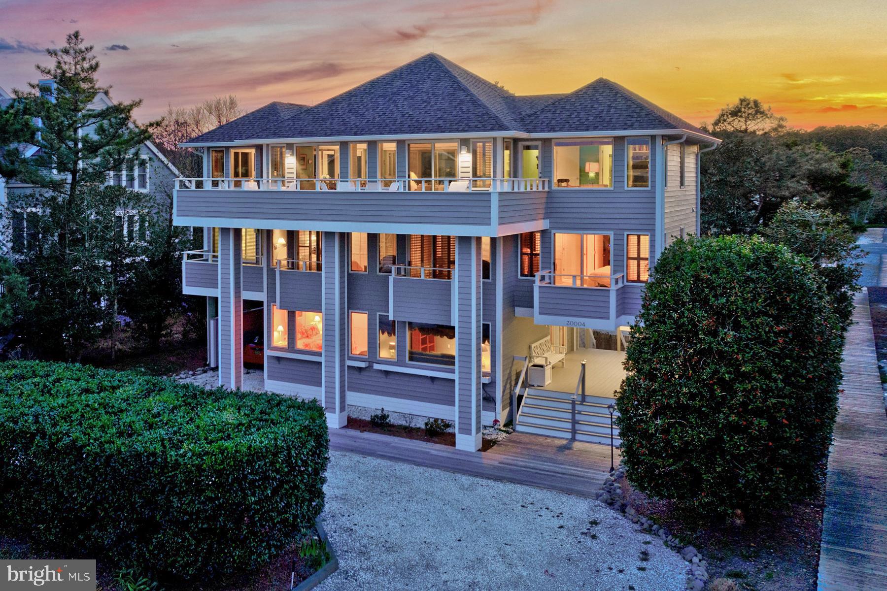 Welcome to 30004 Surfside Drive located in one of North Bethany's most coveted gated communities! Situated on a premium lot, offering ocean views and direct walkway access to a life guarded private beach. Designed with contemporary flair, this custom-built home showcases meticulous craftsmanship and has been lovingly maintained by the original and current owner. Boasting an intelligently designed inverted floor plan with an elevator, the main living and entertaining spaces grace the third floor. Here, a bright and airy living room, open dining area, family room, four-season sunroom, and a well-appointed kitchen with quartz countertops and upgraded appliances flow seamlessly onto an expansive front and rear decks. This area is perfect for hosting gatherings while soaking in the ocean vistas. Large windows adorned with custom plantation shutters flood the interior with natural light, creating an inviting and elegant ambiance. The second floor is dedicated to comfort, featuring five bedrooms and an additional rear deck overlooking a lush and private backyard. Downstairs, the first floor welcomes you with an inviting foyer, an ensuite bedroom, a family room, and a utility room with laundry. Outside, a spacious carport, two outdoor showers, and ample storage spaces cater to beachgoers' needs. The oversized 75 x 158 lot presents endless possibilities, including the option for a pool installation. The property comes fully furnished and boasts strong rental potential. Recent upgrades include a newly installed roof, decking, hot water heater and freshly painted exterior. With no rental obligations for the summer of 2024, this exquisite home is ready for immediate occupancy. Although never rented, a rental projection investment analysis is available upon request. Don't miss this opportunity to experience coastal living at its finest- Call for a private tour today!