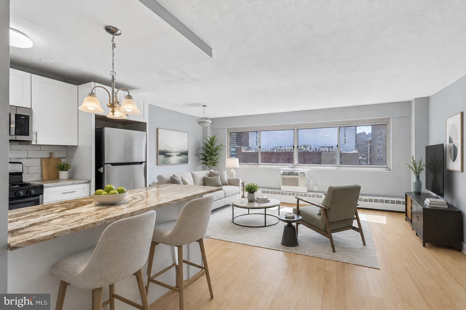 Enjoy unparalleled city living from this rarely offered two bedroom residence just off Rittenhouse Square! Boasting over 860 + sq ft of stylish living space, this spacious home features an open floor plan and remarkable views throughout. The living and dining areas showcase upgraded flooring and a wall of windows which flood your home with natural light and offer unobscured city views. The kitchen has been recently renovated with stainless steel appliances including a gas range, subway tile backsplash, luxury countertops and a convenient breakfast bar perfect for casual dining or entertaining. The primary bedroom is large with dual exposures and ample closet space. The second bedroom is generously sized with a large closet. The bathroom has been enhanced with a tub/shower combination, tiled surround with decorative accent detail, stylish vanity and updated fixtures. Condo fees include ALL UTILITIES (gas, water, and electricity), as well as access to a state-of-the-art fitness center, business center with Wi-Fi, and a 24-hour lobby attendant. Garage parking is available for an additional fee. Perfectly located in Rittenhouse Square, this unit places you in the heart of Center City with fine dining, one-of-a-kind shopping, exciting nightlife, and cultural destinations. The campuses of University of Pennsylvania and Drexel University, 30th Street Station, and major hospitals are all just minutes away.