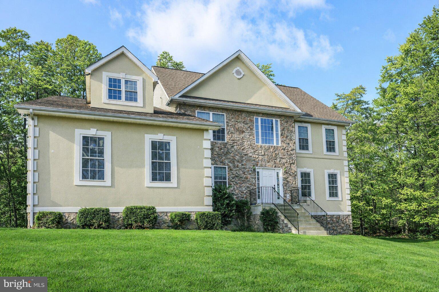 Are you in need of a detached 3 car garage plus an attached 3 car garage? If you are a mechanic or need space to work, this is it! With 4 spacious bedrooms and 2.5 bathrooms, this residence spans 3,566 sq. ft. ,plus an additonal1550 Sq. ft. in lower level providing ample space for relaxation and entertaining. Step inside to discover a warm and inviting interior featuring elegant crown moldings and chair railings that enhance the home’s character. The heart of the home is the country-style kitchen, complete with a generous island, pantry, and modern appliances, including a built-in microwave and self-cleaning oven. The adjoining family room, warmed by a cozy gas fireplace, creates an ideal setting for gatherings. Retreat to the luxurious primary suite, boasting a walk-in closet and a spa-like bathroom with a jetted tub and stall shower. Additional bedrooms offer versatility for guests or a home office. The unfinished basement presents endless possibilities, with daylight windows and a walkout level, perfect for future expansion. Outside, the expansive 3.96-acre lot backs to tranquil trees, providing a peaceful backdrop for outdoor activities. Enjoy evenings on the deck or explore the additional structures, including a spacious detached garage (over 1100 Sq ft inclusing elctricity and upper level) and shed for extra storage. With convenient parking options and a welcoming atmosphere, this home is ready to embrace new memories. Experience the perfect blend of comfort and potential in this delightful property.