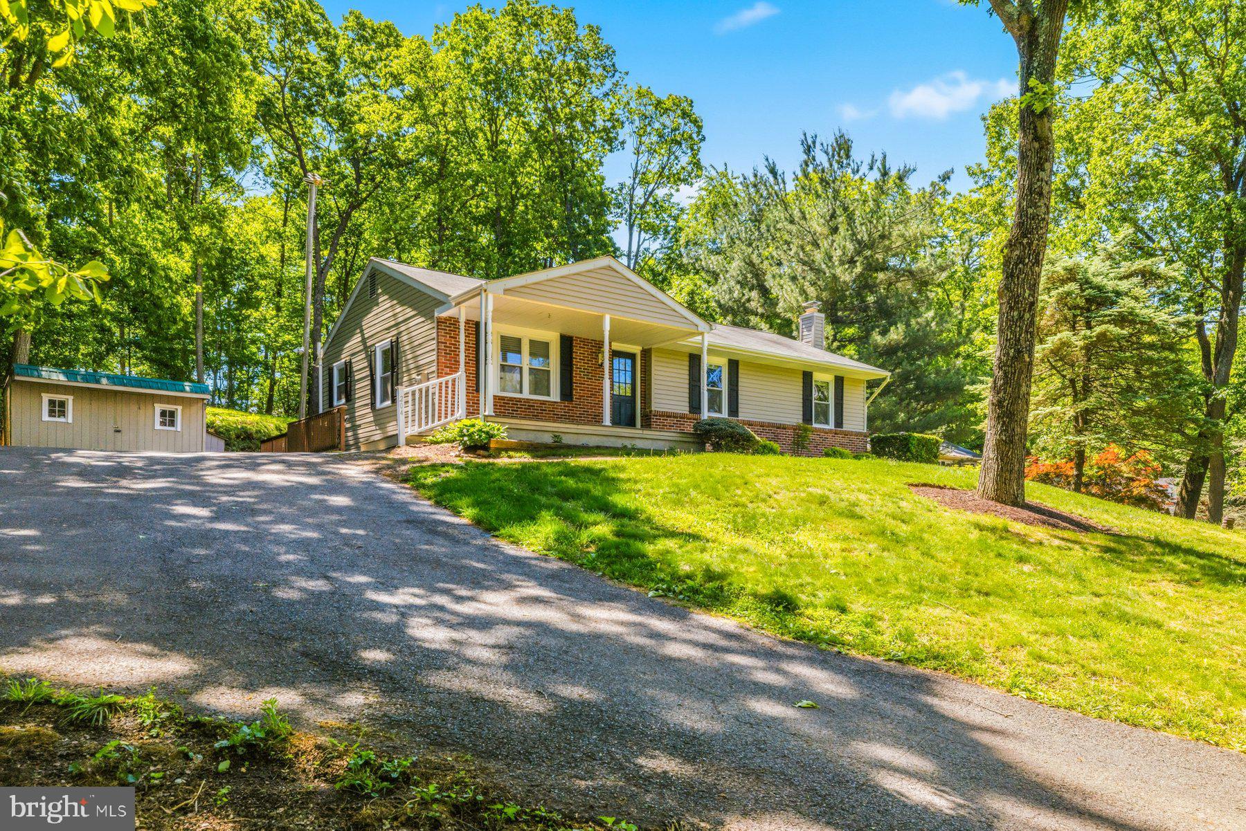 Move-in ready, adorable 4BR/2BA Rancher tucked into the landscaping on a sprawling lot in the quiet area of New Windsor.  Pull into the doublewide driveway, walk past mature trees and a lush green lawn to the covered front porch and the door into your new home. Step inside a home filled with natural light and original hardwood floors.  The main living area offers a large living room, an open-concept dining room, and a kitchen.  The kitchen features abundant cabinets and counter space, a separate pantry closet, stainless steel appliances, and a stainless sink under a window.  Down the hall are two sizable secondary bedrooms, a larger primary bedroom, and a full bath with a jetted soaking tub.  The lower level is finished offering additional living space that features the fourth bedroom, a full bath, a large recreation room with a wood-burning stove, an adorable laundry room, storage, and a walk-out to the side yard.  From the main floor step outside to an extended wood deck that tucks into the landscape in the sprawling yard, which features mature trees, green space, a shed, and so many possibilities.  This home is ideal for any new homeowner and is located near shopping, restaurants, and commuter routes.