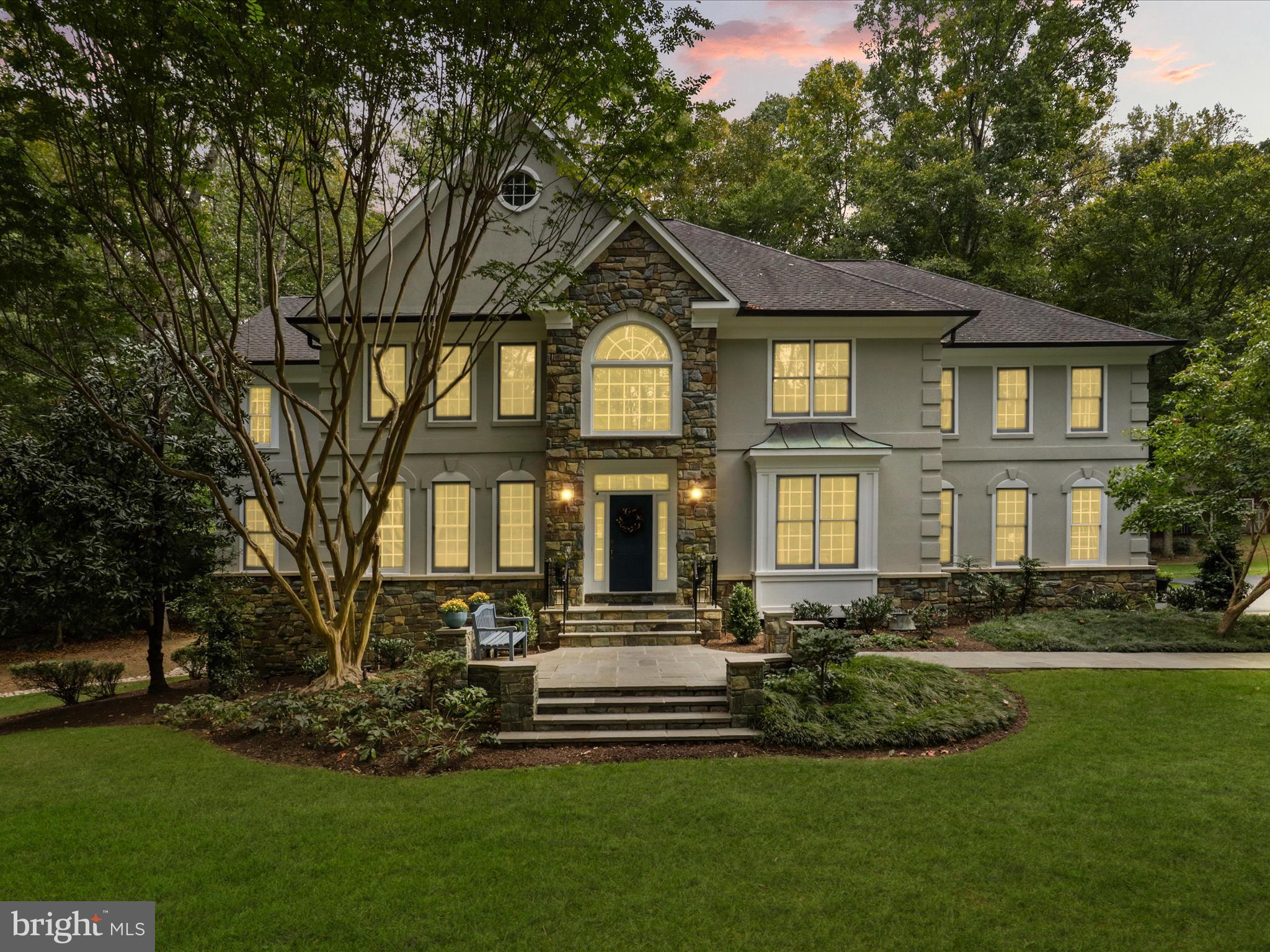 Super Price on this Exceptional home, combining thoughtful design, top-tier upgrades and the tranquility of nature!
 It has over 8,000+ finished square feet of elegant indoor and outdoor living with  a total of 5 bedrooms and 4.5 baths! 
The professionally landscaped property features a multi-level Pau Lope hardwood deck with curved railings, firepit seating, retractable awning, and upper/lower integration through flagstone patios, stone pillars, and custom arbor accents. The entire home is wrapped in four-sided Dry-Vit exterior in stone gray trim, complemented by whole-house copper gutters and a well-water treatment system.
Enjoy resort-style outdoor living with a 20’x40’ flagstone-surrounded pool, custom stone hot tub, and a fully equipped post-and-beam pool house featuring a vaulted ceiling pavilion with woodland carvings, a seasonal full bath, and a dedicated equipment room. A separate wood-burning outdoor fireplace with grill shelf and a charming garden shed complete the setting.
Inside, the main level features an open layout with hardwood and tile flooring throughout. The grand hallway doubles as a dining or entertaining space and features dual chandeliers and elegant Bradbury & Bradbury wallpaper. A marble powder room, coat closet, and butler’s pantry with wine storage and custom cabinetry offer functionality and charm.
The formal Library/Home Office includes cherry cabinetry, faux tin ceiling, faux leather walls, and a gas fireplace with marble surround. The soaring Family Room boasts a floor-to-ceiling dry-stack stone fireplace, heart pine floors, arched Palladian windows, double ceiling fans, and sliding doors that open to the deck. An integrated AV system powers four main-level audio zones with surround sound in the Family Room.
The Chef’s Dream Kitchen includes a 6-burner Viking gas range with griddle and 1.5 ovens, additional Viking wall oven and warming drawer, Sub-Zero fridge, wine fridge, granite counters, and California Closets pantry system. The sunny breakfast nook overlooks woodland views and year round foliage.
A two-level custom Sunroom offers stunning panoramic views. The main level includes Saltillo-style tile and a dual-sided gas fireplace shared with the Library. The upper-level loft bedroom features a cathedral ceiling, library shelf, and shuttered windows on all sides—ideal as a guest suite or secondary primary bedroom.
The fully finished walk-out basement includes a theater room with Art Deco design, platform seating, and surround sound.. Additional spaces include a rec room, gym area, and private guest/office suite with full bath.
Upstairs, flexible layouts allow for four bedrooms or two primary suites. The main Primary Suite features a private sitting room/office, hardwood entry, illusion of an outdoor tent style bath with Jacuzzi tub, walk-in shower, dual vanities, two large walk-in closets, and ceiling fan. The Secondary Suite has a loft-style entry, double-height ceilings, extensive windows, walk-in closet, and private bath with double vanity, walk-in shower, tub, and linen storage. A third ensuite Guest Room includes its own bath, ceiling fan, and wooded views. 
Additional highlights include dual staircases, chandelier-lit upper hallway, custom display niches, and stunning seasonal views from every room. This home combines thoughtful design, top-tier upgrades, and the tranquility of nature in one remarkable property.  Original owner.  
Twelve Oaks is a private enclave of 18 custom homes on five-acre lots within the protected Occoquan Watershed. Perfectly located between the Fairfax County and Prince William Parkways, this Fairfax Station estate is just minutes from Burke Centre and historic Old Town Clifton, offering a rare combination of privacy, space, and convenience.