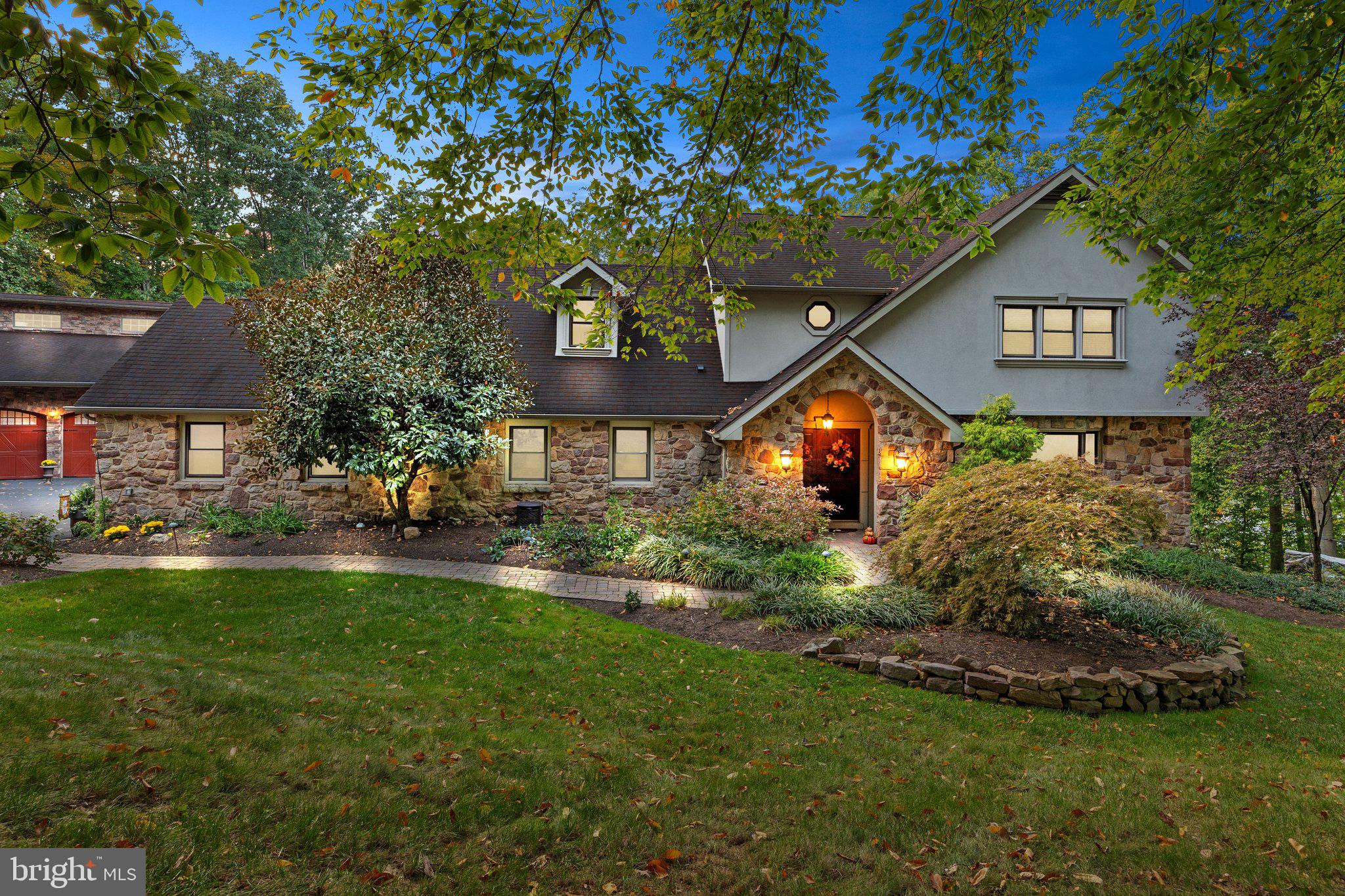 Tucked away on a private dead-end street in the highly sought-after Upper Moreland Township, this exceptional 5-bedroom, 4.5-bathroom home sits on a sprawling 1.55-acre lot, offering the ultimate in privacy and luxury. As you approach the home, the grand double-door entry opens to a dramatic 2-story foyer, featuring elegant ceramic tile flooring and an oak staircase with wrought iron railing. The formal living room is a beautiful space with hardwood floors, a stunning stone wall with a wood-burning fireplace, and a mantle that adds a warm, inviting touch. Adjacent to the living room, the sunken family room features soaring vaulted ceilings and floor-to-ceiling windows that fill the space with natural light, creating a seamless connection to the outdoors. The heart of the home is its recently remodeled (2023) gourmet kitchen, a true chef’s dream. The expansive 20-foot center island, with seating for up to 15 people, anchors the space and is complemented by top-of-the-line GE Cafe appliances, including a 48" commercial-grade range, custom chimney hood, side-by-side 60" refrigerator/freezer, and a full ice maker. The kitchen also boasts a farmhouse-style sink, two coffee bars, a trash compactor, and custom mocha cabinetry that reaches from floor to ceiling, all accented by crown molding. Imported quartz slab countertops and a honed Carrara marble backsplash add an extra layer of sophistication. A sliding glass door leads from the kitchen to a two-tiered custom TREX deck, perfect for outdoor entertaining, with aluminum black railings, stack stone walls, and Dryvit stucco accents. Below the deck, there’s additional storage space for convenience.
The main floor is further enhanced by a spacious bedroom with an en-suite full bath, ideal for guests or multi-generational living, and a well-appointed laundry/mudroom with direct access to the garages. The second floor is home to the luxurious primary suite, complete with hardwood flooring, a private sitting room, a large walk-in closet, and an en-suite bath featuring tumble marble tile, a frameless glass shower, and marble flooring. Two additional generous-sized bedrooms share a full bathroom with dual vanities and a tub/shower combo, offering comfort and privacy.
The fully finished basement extends the home’s living space and is perfect for both relaxation and entertaining. It features an additional bedroom, full bathroom, game room, two office areas, and a cedar closet, all with recessed lighting and ceramic tile flooring throughout. The basement also offers ample storage, including under-stair storage, and includes surround sound wiring. Sliding glass doors lead directly to the backyard, where you'll find a private patio and a Jacuzzi, perfect for unwinding.
This property also includes a truly unique and impressive 3300 sq. ft. garage/Party Hall, which was originally designed for custom car storage but has since been transformed into an entertainer’s paradise. This expansive space includes a dance floor, a game area, a living/dining space, and a built-in wet bar with a pizza oven and fireplace, ideal for hosting large gatherings. The barn is equipped with recessed lighting, surround sound, brick paver and concrete flooring, and two rear garage doors that open to the backyard. Additional features include a half-bath with a toilet and urinal, a walk-up attic for extra storage, and a 1-car attached garage. The backyard is equally impressive, featuring a charming two-story "princess house" is perfect for children or as a whimsical retreat. The entire property is surrounded by lush landscaping, ensuring ultimate privacy and serenity, while the expansive outdoor spaces, including the custom deck, patio, and Jacuzzi, provide plenty of room for entertaining or simply enjoying the tranquil surroundings. This remarkable home is a rare find, offering unparalleled luxury, craftsmanship, and space in one of Upper Moreland Township’s most private and prestige locations.