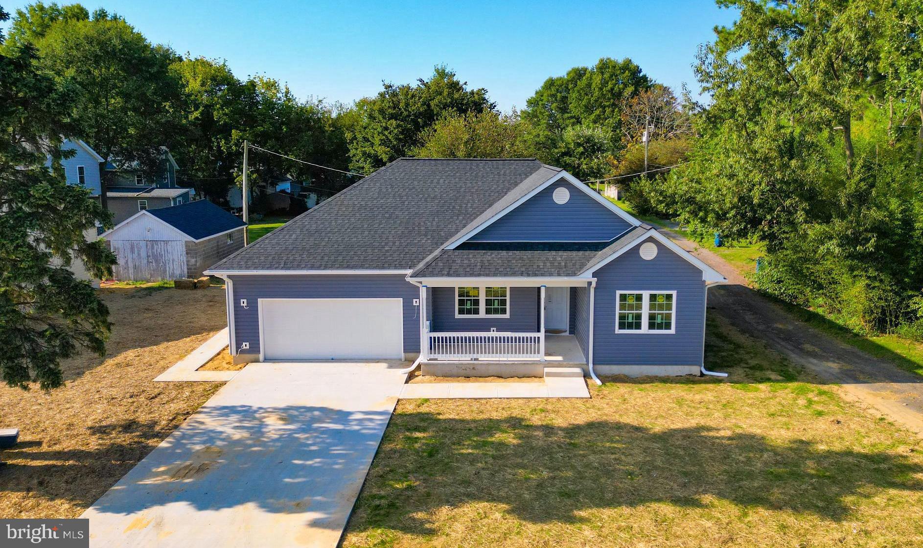 This beautiful home is waiting to make it  yours -- come see today and contract before someone else does!  The beautiful "home" has so much to offer you.  From the warm and welcoming front porch to the large concrete patio, it has your name on it.  The large living room sets off the open floor plan that also incorporates the beautifully designed kitchen with all the latest in stainless steel appliances and a large pantry with four shelves as well as the dining area that hosts a beautiful 6' Pella slider.   The owners' suite is designed with a large walk-in closet (approximately 13' x 7') and a bath with a lovely tiled shower, double vanity, and a dual-flush toilet.  The other two bedrooms are on the opposite side of the home as well is other full bathroom.  All bedrooms have ceiling fans with remotes.  The large living area showcases a wall electric "fireplace" for a warm ambiance, offering heat or just flames and no heat.  The concrete driveway takes you to the garage, which has room for two vehicles and a workbench as well as storage.  Lovely 20' x 18' patio to enjoy cookouts with family and friends.  The sprinkler system and fire hydrant will keep buyers' home-owners insurance rates at a lower price.  Access door to the attic for more storage is located in the garage for convenience.  The sidewalk from the drive gives side entrance into the garage to help keep the interior of your new home clean - as well as the "utility/mud" room is located right off the garage also.  This beautiful Town of Ridgely (some of us have nicknamed it "The Mayberry of the Eastern Shore")  is a highly desired area in which to live -- its own fire department and police department as well as beautiful park, "old" train station, bank, gas stations, stores, eateries, and more, are ready to serve you!   A builder's one-year warranty is also included.  Come today, sign your contract today and start packing to move.  Schedule with agent to see this well-designed beauty!   Enjoy the holidays in your new home!!!