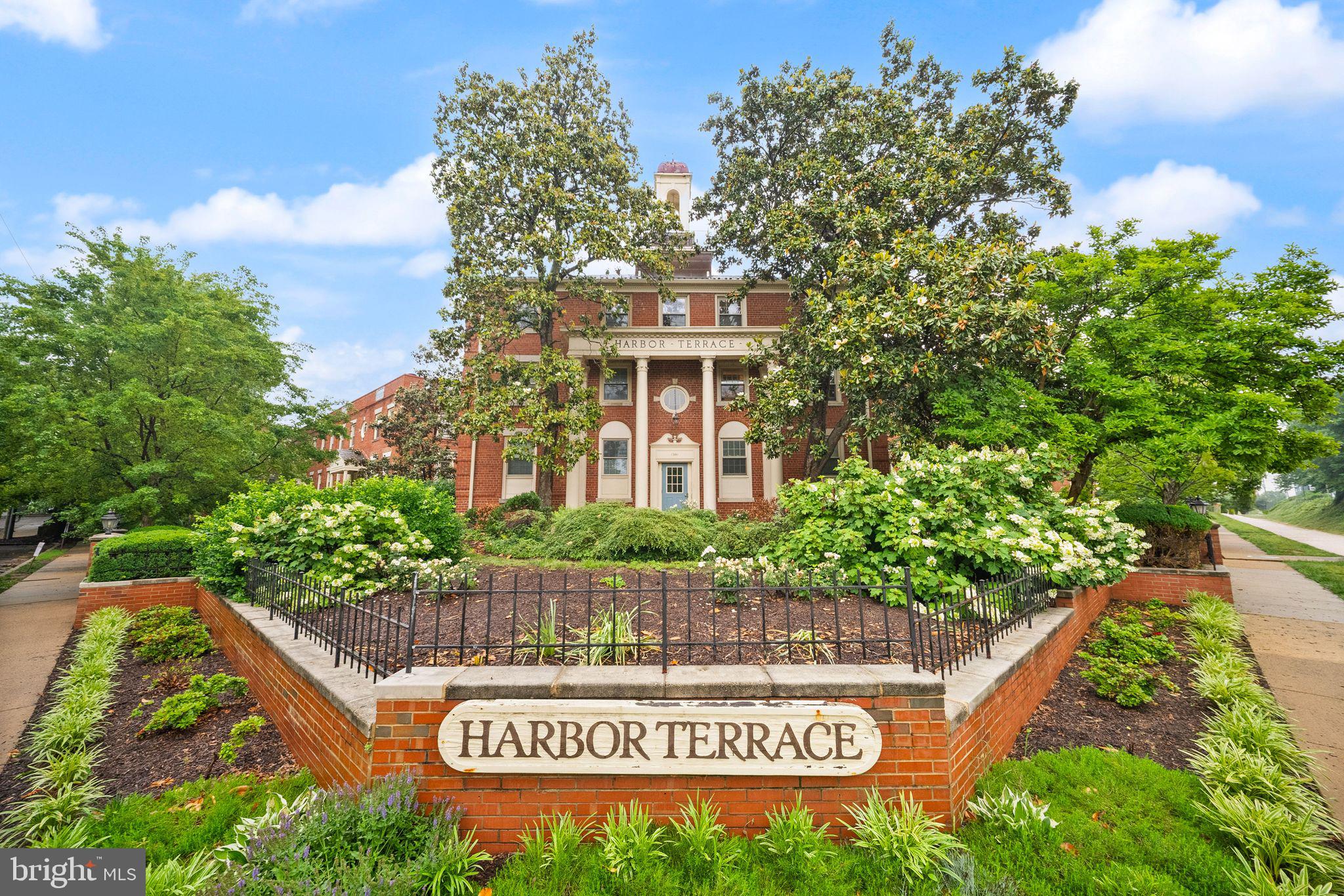 Welcome to this bright and inviting residence in Harbor Terrace of Old Town Condominiums—a charming garden-style community tucked into north Old Town Alexandria and surrounded by mature landscaping, brick architecture, and thoughtfully maintained green spaces.

Inside, this home offers an easy, comfortable layout with warm hardwood floors flowing throughout the main living areas and generous windows that bring in natural light from multiple exposures. The spacious living room is anchored by a fireplace and offers flexible space for both everyday living and entertaining. Just beyond, the semi-open kitchen features abundant cabinetry and a breakfast bar that keeps the space connected while maintaining definition.

The bedroom is generously sized with ample closet storage and room to create a true retreat, while the full bath offers timeless neutral finishes and practical built-in storage. A dedicated laundry closet with an in-unit washer and dryer adds everyday convenience without sacrificing living space.

Life at Harbor Terrace extends beyond the front door. Residents enjoy beautifully landscaped grounds with gathering spaces including a gazebo, pergola, and grilling area, creating a tucked-away neighborhood feel while remaining close to everything. The community backs to the scenic multi-use trail connecting the Potomac waterfront corridor and offers easy access to Old Town shops, dining, commuter routes, transit options, and nearby employment hubs.

Additional conveniences include resident and guest parking, water and trash service included in the condo fee, and extra storage.

A rare opportunity to enjoy low-maintenance living in one of Alexandria’s most connected and established communities.