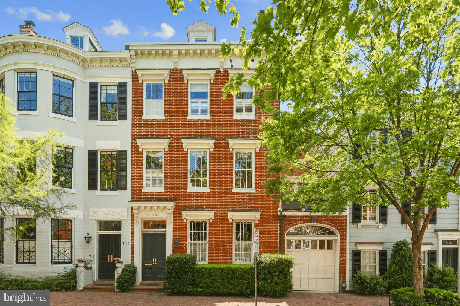 Located on one of Georgetown’s most iconic East Village blocks, surrounded by some of the neighborhood’s most distinguished historic homes, this circa 1845 Federal residence blends classic architecture, exceptional scale, and thoughtful updates across four levels of light-filled living space, complete with a rare 1-Car Garage, just moments from Georgetown’s cafés, shops, and waterfront. Expanded in 1890, the home carries a quiet but meaningful history. An early restoration by a young Archie and Selwa "Lucky" Roosevelt in the 1950s helped define the home's enduring character and extraordinary sense of light and openness, most notably through the addition of an expanse of windows that frame the deep garden and bring “the outside in,” creating a seamless connection between interior living spaces and surrounding greenery.  Behind its elegant façade, the home unfolds with generous proportions, soaring ceilings, four fireplaces, and refined period details including large-paned windows and original millwork. The main level is anchored by gracious living and entertaining spaces, including a handsome library with wood-burning fireplace, marble-floored foyer, light-filled dining room, and a fully renovated chef’s kitchen with premium appliances. The kitchen opens to a sun-filled breakfast room with windows on three sides and French doors leading to a private landscaped garden and patio, an ideal extension of the living space, effectively bringing the "outside in," as its design intended. The garage offers main level access as well through the butler's pantry into the kitchen. The upper levels continue the home’s balance of scale with comfort, featuring a grand double parlor with a sun room and wet-bar, perfect for entertaining, a serene primary suite with skylit bath, and flexible additional bedrooms and study spaces. Thoughtful improvements enhance everyday living, including upgraded baths, a dedicated upstairs laundry, a private second-floor patio, and a reconfigured top floor with expanded dormer and open views. Outdoors, the deep landscaped garden offers rare privacy and calm in the center of the city, an escape that feels far removed from its central Georgetown location. Modern systems, including supplemental HVAC, integrated speakers, security, and solar panels, support effortless living. This is a home defined by light, classic architecture, and an extraordinary garden connection, an elegant and deeply livable retreat with its own attached garage in the heart of one of Washington’s most coveted neighborhoods. Don't miss this hidden gem in the heart of Georgetown!
