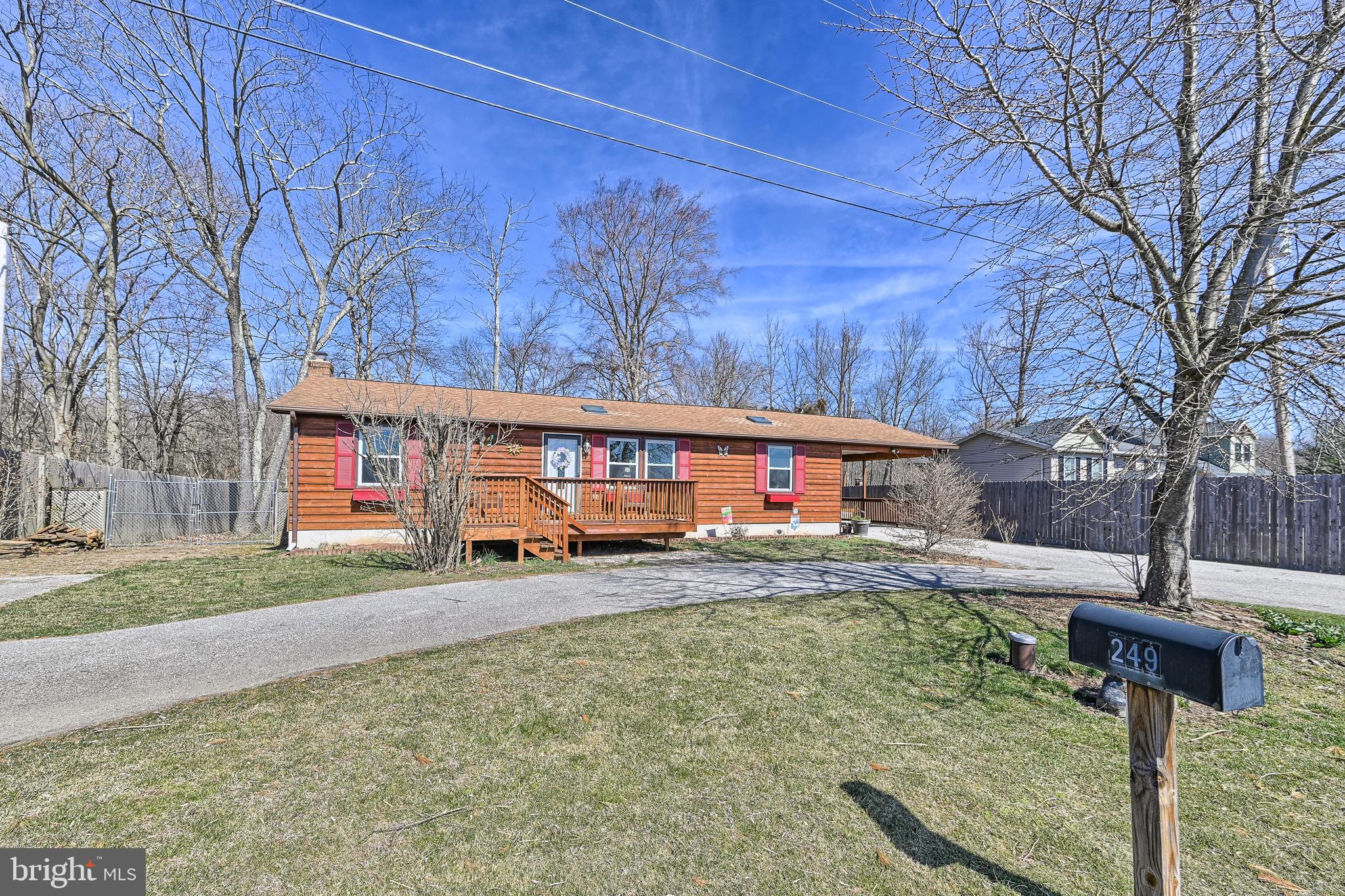 Private setting with orchard views to the front and woods to the back.  3 bedrooms and 2 baths freshly painted and ready for the next owner.  Easy clean laminate flooring and 1st floor laundry.  Large eat in kitchen with newer appliances and countertop.  Skylights were replaced with a 10 year warranty.  Fully finished basement with bilco exit -  family room, office, exercise room, mud room and workshop.  All heated with a propane wall heater.  UV light and softener.  Circular driveway for easy access and plenty of off street parking.  Attached carport.  The cedar siding and decks were stained in 2020.   The yard is totally fenced in and the front and rear decks make great spaces to enjoy the outdoors.