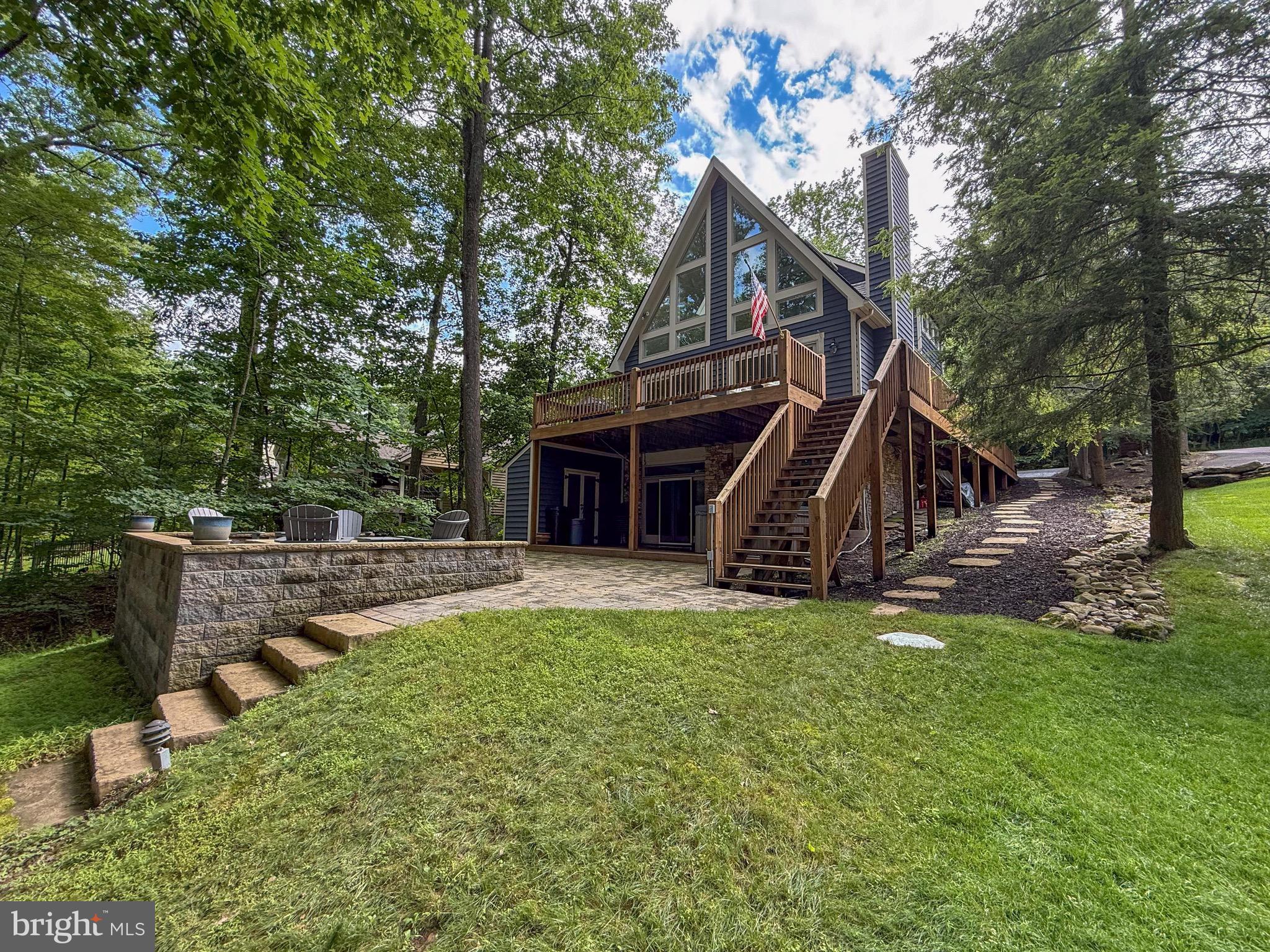 Welcome to 86 shingle Camp Terrace - a remarkable, 4 bedroom, 3.5 bathroom lakefront home in one of Deep Creek's most desirable coves. Offering 60' of gradual lake frontage with deep water off the dock in a no wake zone cove, you are sure to experience the best that life at the lake has to offer. Located on a private street with no outlet with only a few homes beyond this one provides a low-traffic feel that can be hard to replicate. The functional design offers a large, main level bedroom suite with its own full bathroom, powder room, kitchen, dining and living room with wood burning fireplace, and tall chalet ceilings to capture the eastern light. The upper level offers another large bedroom suite with full bathroom, walk in closet and loft balcony, perfect for computer work before a day on the lake. The lower level has brand new carpets throughout, an all new wet bar with sink, beverage fridges, ice maker and kegerator, as well as 2 more bedrooms, 1 full bathroom, laundry room and more storage. Enjoy a peaceful evening in the hot tub on the lower level deck or a bonfire on the lighted patio looking over the lake. The path to the water offers a lighted pathway down to the lake shed and Type-A dock. Located just 5 minutes from the top of Wisp Resort and a short boat ride to almost any restaurant on the waterfront, this setting puts you exactly where you need to be at Deep Creek Lake. If you have been searching for a home at the lake and haven't found it, this may be the one. Call today to schedule a private showing, opportunities like this do not last!