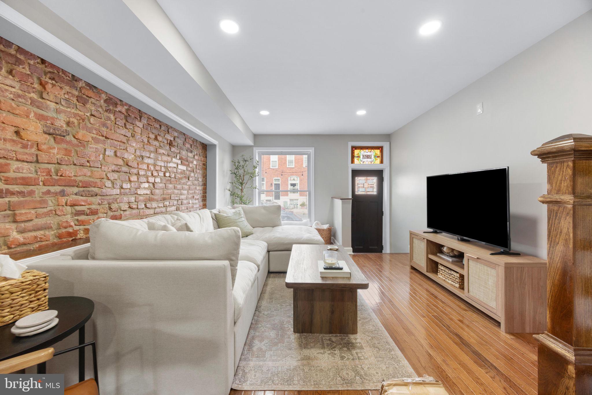 Welcome to 636 S. Kenwood Avenue—a beautifully appointed four-bedroom, three-bathroom townhome that perfectly blends timeless Baltimore charm with the modern features today's buyers are searching for. From the moment you step inside, you'll be captivated by the rich hardwood floors, striking exposed brick walls, and abundant natural light that fills every level of this spacious home.

The heart of the home is the expansive kitchen, thoughtfully designed with an oversized center island that offers the perfect space for cooking, entertaining, or gathering with family and friends. Just off the kitchen, step onto the generous rear deck—an ideal extension of your living space for morning coffee, summer barbecues, or relaxing evenings outdoors.

Upstairs, you'll find spacious bedrooms designed for comfort, while the fully finished lower level offers incredible flexibility with two additional bedrooms, a full bathroom, and ample living space—perfect for guests, a home office or a fitness room.

With three full bathrooms, generous square footage, and a layout that truly lives large, this home offers the space and versatility that's becoming increasingly difficult to find in the city. Every room feels bright, welcoming, and ready for its next owner to make it their own.

Located in one of Southeast Baltimore's most convenient neighborhoods, you'll enjoy easy access to Canton, Patterson Park, Johns Hopkins, local restaurants, coffee shops, and major commuter routes.

Homes that offer this much space, character, and functionality don't stay on the market for long. Schedule your private tour today and discover why 636 S. Kenwood Avenue should be your next home.
