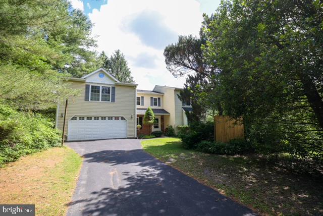Nestled in the charming North Carroll Farms community, this delightful Colonial home offers a perfect blend of comfort and functionality. With 4/5 spacious bedrooms and 2.5 bathrooms, this residence spans over 3830 sq ft, providing ample space for relaxation and gatherings.  Step outside to a 1.87-acre lot, with lush greens and landscaping, to include gardens and lower lot stream.  The heart of the home features a traditional floor plan with a cozy family room off the kitchen, ideal for entertaining. The country-style kitchen boasts an island and an eat-in area, perfect for casual meals or morning coffee. Enjoy the warmth of a wood-burning fireplace in the inviting living space, complemented by beautiful wood floors. The upper-level laundry adds convenience to your daily routine, a unique upper-level floor plan allows for private space and lots of versatility.   The unfinished basement offers endless possibilities for customization.  shed/outbuilding for additional storage or hobbies. Located in a vibrant neighborhood, residents benefit from nearby parks and community amenities that foster a sense of belonging. Explore local trails, enjoy recreational activities, or simply unwind in the serene surroundings. This home is not just a place to live; it's a gateway to a fulfilling lifestyle in a welcoming community. Experience the perfect blend of comfort, space, and community in this charming North Carroll Farms residence. Original build approved for 3 BR septic- * New roof 2025 with transferrable warranty