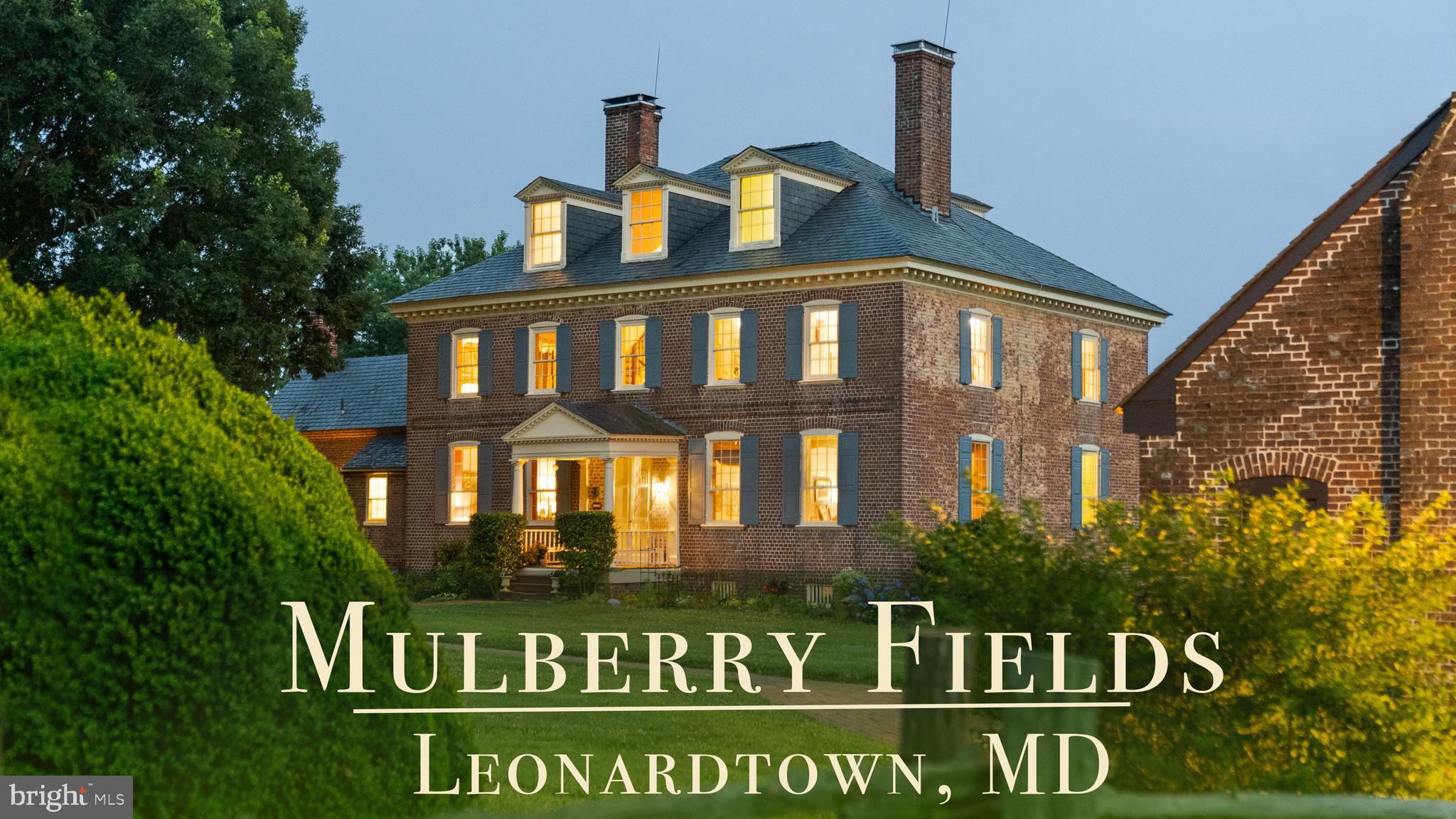 Welcome to Historic Mulberry Fields, situated on just under 500 ac of fertile land with a mile-long view of the Potomac River’s white sand shoreline, truly one of a kind. As you drive along the cedar-lined driveway, you are transported back in time as the magnificent manor house appears in front of you. It is the only remaining Georgian manor house in St. Mary’s County today. From the south façade, the magnificent mile-long “Avenue Field,” lined with trees stretching to the Potomac River provides a breathtaking panoramic view downhill to the white sandy riverbank.

The interior of the manor house is of simple and educated taste. The grand center hall and the 2 front (south) rooms (the great room and dining room) have walls of rectangular raised panels to the ceiling, making it one of the most completely paneled 18th-century houses in Maryland. Throughout the house, many original moldings, doors, and mantels are intact. Air conditioning and heating were added to all rooms. The owners retained an architectural firm and have plans - approved by the Historic Trust - for a renovation that would enlarge the kitchen, the bathrooms and adding another wing to the house on the west side.

Flanking each side of the north entrance are 2 historic dependencies, both similar in design. Each is of brick, 2-story in height. They were placed symmetrically north of the mansion, forming a rectangular court with the Kitchen Garden, Bowling Green and Orchard separated by a row of large boxwoods. These buildings were used as service buildings with the East dependency as “The Kitchen” and the West dependency as the “The Weaving House.” These structures were used to house slaves, such as cooks, stable hands, waiters, and housekeepers who were tasked with running the household and gave the mansion and outbuildings the appearance of a busy village. “The Kitchen” has been remodeled and now serves as a guest cottage, while the “Weaving House” retains its original historic riven clapboard partition walls, floors, doors, and hardware. Next to the 2 dependencies flanking the Manor House are numerous other historic buildings, such as the “Dairy” and the “Meat/Smoke House” (both east of the Manor House). Other historic buildings include a Carriage House, a Garage/Tool Shed, an Art Studio, a Pole Barn, a Horse and Cattle Barn, a Tobacco Barn, a remodeled Sheep Barn, 2 Equipment Barns, a Farmhouse, and an old dwelling that could be remodeled and turned into a rental unit.  

Several buildings were added in the 1930s. These include 6 occupied rental units, incl. 3 units in what was previously the Sheep Barn, a 4-BR Farmhouse, a 1-BR Cottage in the renovated “Kitchen" and a 1-BR Trailer. Taken together, these currently produce an income of $70,000.  Add'l income is provided by leasing the fields for farming and from the U.S. Navy that keeps a navigation signal on the Potomac River. More income can be obtained by renovating some of the existing buildings. With that Mulberry Fields could have a total of twelve rental units.

Mulberry Fields was added to the National Registry of Historic Places in 1973. The Maryland Historical Trust Deed of Easement ALLOWS LIMITED INDUSTRIAL OR COMMERCIAL activities to be conducted at Mulberry Fields if the external appearances of its buildings are not altered (please ask for more info). Owners of Mulberry Fields must abide by a Conservation Easement, a Historical Preservation Easement, and three Rd Easements. Appr. 100 acres of land is leased out for farming and 300 acres is forest. 

This unique historic property is close to Leonardtown, Lexington Park and Solomon’s Island with numerous historic sites, wineries, antique shops, art galleries and restaurants, Deerfield Airport (private jet) as well as St. Mary’s County Regional Airport. 1h15 min drive to Washington DC and its major airports - Dulles Int’l Airport, and Reagan Nat’l Airport. MORE IN-DEPTH HISTORY AVAILABLE UPON REQUEST.