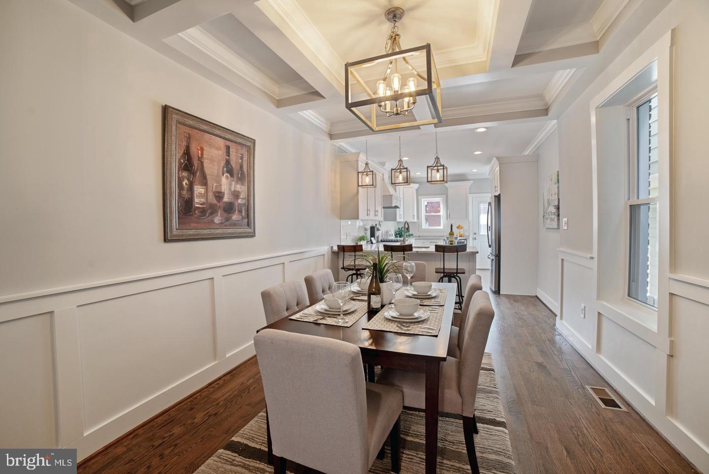 This stunning three-story home, a masterful renovation by Chesapeake Custom Properties LLC, offers the perfect blend of historic charm and modern luxury. With CHAP tax credit with 4 years left, this 15-foot-wide home boasts over 2,000 square feet of meticulously finished space, including three bedrooms, three-and-a-half bathrooms, and two-car lighted parking. Every detail has been carefully considered to deliver a home that is both elegant and functional.

The home greets you with gorgeous real hardwood floors, soaring 9-foot-plus ceilings, recessed lighting, exposed brick, and intricate custom trim work. The chef’s kitchen is a showstopper, featuring 42-inch custom-made soft-close cabinetry, a hand-milled range hood, gleaming quartz countertops, upgraded stainless steel appliances, a built-in wine fridge, a breakfast bar, and a pot filler. The light-filled living room with exposed brick and the dining room, enhanced by a coffered ceiling and shaker-style wainscoting, provide stylish spaces for relaxation and entertainment.

On the upper level, the thoughtful design continues with 10-foot tray ceilings in the front bedroom, a hallway linen closet, and a dedicated laundry center with a front-loading washer and dryer. The second-story bathroom features a custom tile design with a frameless glass tub-shower combo, making it ideal for families with young children. The owner’s suite is a luxurious retreat with a spacious walk-in closet and an exquisite primary bathroom. The oversized frameless glass shower with dual shower heads, a dual vanity, Bluetooth-enabled audio, and mood lighting creates a spa-like experience right at home.

The fully finished lower level offers additional living space, including a club room, a bedroom, and a beautifully tiled full bathroom. Throughout the home, ample storage solutions, including a crawl space and linen closets, ensure practicality meets sophistication.

This smart home is outfitted with state-of-the-art technology, including smart light switches, door locks, and Nest thermostats for two heating and cooling zones, allowing you to control the entire home conveniently from your mobile device.

The rooftop deck is a true gem, offering breathtaking panoramic views of the water and the city skyline, making it the perfect spot to relax or entertain. Combining luxury, technology, and timeless design, this home provides everything you could want for modern living in the heart of the city.