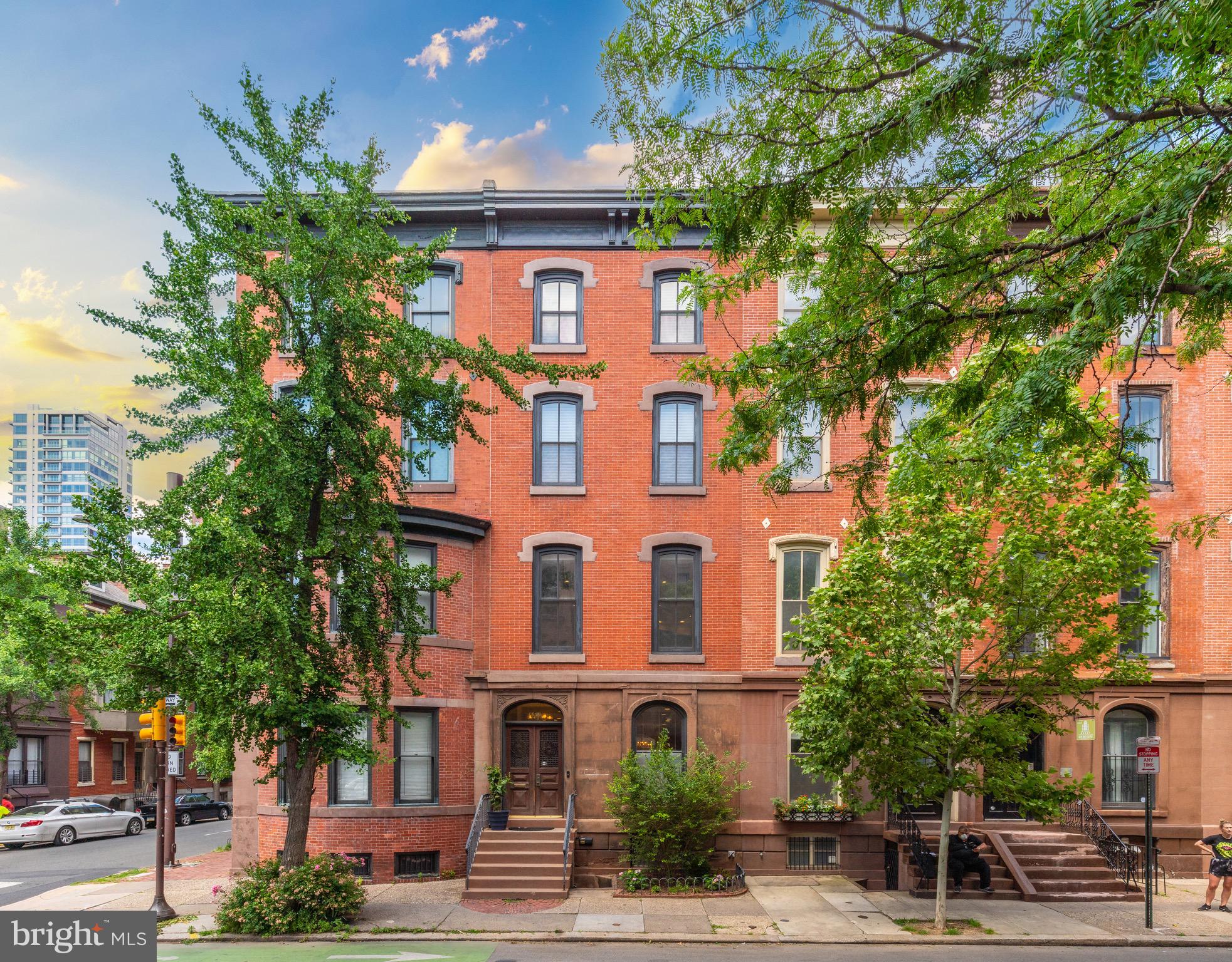 Welcome to 1539 Pine - This grand & elegant 4 story, Rittenhouse Square brownstone offers a harmonious blend of old world charm and modern finishes. There are so many reasons to fall in love with this home from its high ceilings, size and scale, parking, large beautiful windows, gorgeous banisters with exposed brick accent that flows gracefully up and down the stairwell to its multiple outdoor spaces and perfect Rittenhouse Square location. You will feel right at home! This home has been completely renovated by the current owners. Updates include new mechanical systems (HVAC, electric, plumbing), refinished hardwood floors throughout, detailed millwork, sheetrock walls and ceilings, lighting, paint, and remodeled chef’s kitchen and bathrooms with Carrarra marble floors and surround. The property features a back gated car port with garage door opener (see agent for details on the parking) , rear trex deck that is great for barbecuing and entertaining friends and family, 6 fireplaces, and a large roof deck with stunning skyline views of the city.  This legal duplex provides the flexibility of a lower-level unit with an independent entrance, offering income potential or a private au pair suite. A gated driveway featuring a garage door for added convenience. The first floor of this lovely home features an open floor plan with a living room, dining room, powder room, and beautiful kitchen with ample cabinet space, breakfast bar, large island, granite countertops, stainless steel appliances and 2 fireplaces. The 2nd floor boasts wide hallways and 2 great rooms with 13 foot ceilings, each with a fireplace and large, opulent windows along. The second floor is great for entertaining your guests and has a perfectly located, full guest bathroom. The 3rd floor boasts a large primary bedroom with fireplace, spacious closets, and stunning full bath. The sizable 2nd bedroom features a fireplace and full bathroom, spacious closets, and storage. The 4th floor includes three more bedrooms, each with a full bath and a dedicated laundry room. There’s also a sitting area with roughed-in plumbing for a wet bar area and stairs up to the roof deck with stunning views of the skyline and surrounding neighborhood. This home has so much to offer beyond its location and skyline views! Just steps to shopping and eating at the best restaurants Philadelphia has to offer, surrounded by history and local venues, yet still has the convenience, privacy, and ambiance of your own home.  1 year pre paid parking space across the street included with this purchase.  Walking distance to all major hospitals and Center City, close to colleges and major highways.