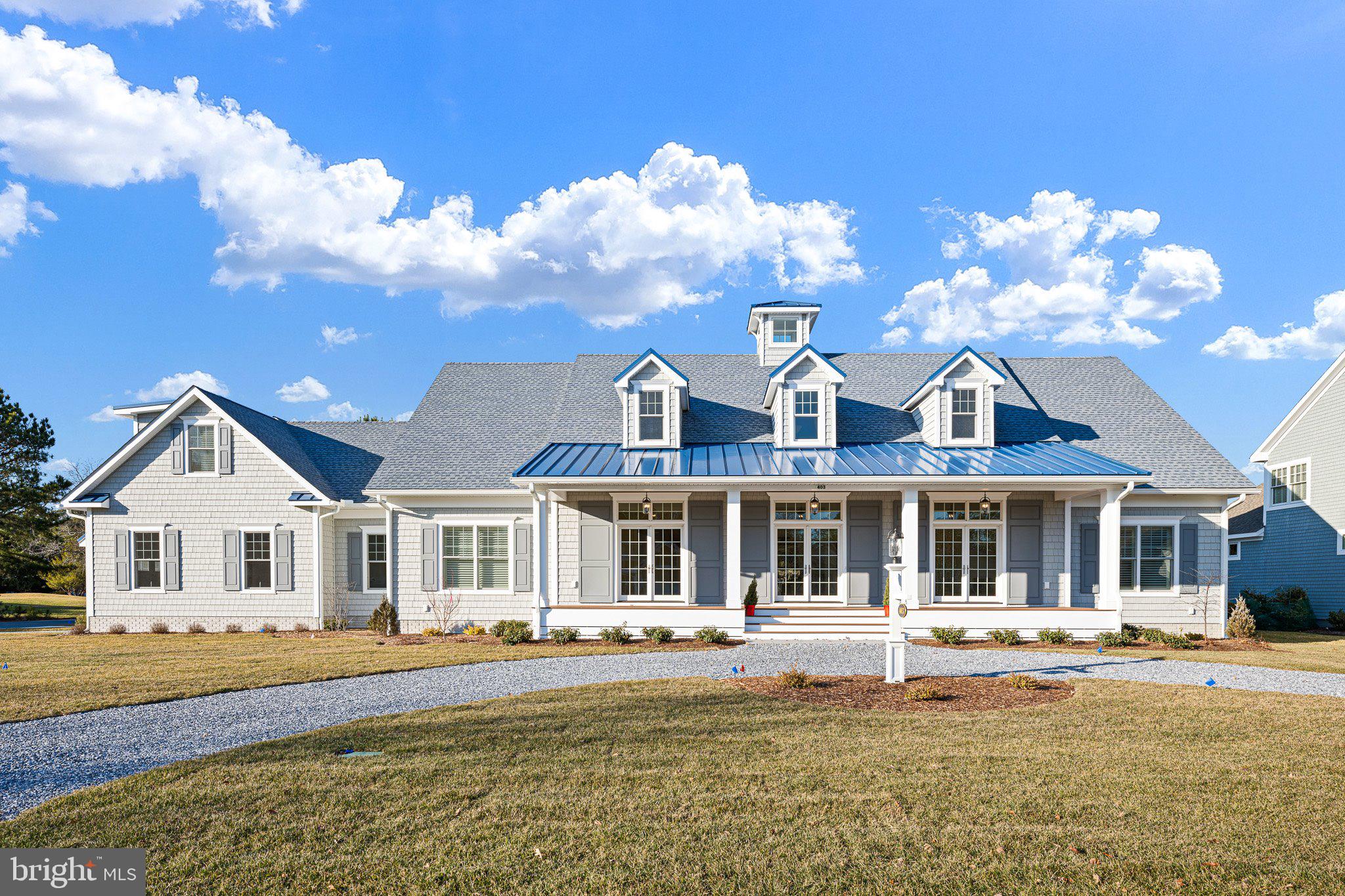 Welcome to 403 Canal Way East, an extraordinary brand-new custom build in the highly sought-after Bethany Beach community of Salt Pond. This luxurious 4,800 square foot residence is a masterpiece of thoughtful design and elegance, nestled on a generous one-third acre corner lot overlooking the 14th fairway of The Salt Pond Golf Course.

As you approach via the circular drive, the expansive front porch and stunning double door entry set the tone for the exquisite interior. Step into the grand two-story foyer, adorned with wood floors and custom inlay, and be immediately captivated by the elegant formal living room with a fireplace to your left and a formal dining area to your right. Both spaces feature French doors that open onto the front porch, creating an inviting flow for entertaining.

The heart of this home is the open concept living area, where the gourmet kitchen stands as a testament to luxury and functionality. It boasts stunning quartz countertops, a commercial-grade, six burner Wolf cooktop with griddle, double ovens, a Sub-Zero refrigerator, and a hidden microwave. The central island offers barstool seating and a prep sink, complemented by a generous pantry and ample storage. Adjacent is a beautifully appointed butler’s pantry with high-end cabinetry, a wine fridge, and a lighted display cabinet.

The adjoining family dining area features a built-in bay window seat with storage, seamlessly flowing into the bright living space with coffered ceilings, a fireplace, and custom cabinetry. French doors lead to a stunning all-season sunroom with vaulted ceiling, alongside an adjacent screened porch—ideal spots for relaxation.

The main level also includes two spacious ensuite bedrooms with luxurious bathrooms, featuring double sinks and thoughtful accessibility features. The primary suite offers a private deck with a trellis, a soaking tub, and a walk-in closet with custom cabinetry. High ceilings and exquisite wood floors throughout enhance the home's generous and unified atmosphere.

Completing the main level is an oversized two-car garage with commercial-grade doors, epoxy floors, and access to a mudroom that connects to the screened porch and an outdoor shower. Modern comforts are assured with the home's dual geothermal HVAC system.

The second floor offers a vast open space perfect for a variety of uses, along with a large bonus room ideal for a home office or additional living space. Two more ensuite bedrooms and two ample walk-in storage areas add to the home's versatility.

Every detail, from custom tile work to high-end moldings and art niches, underscores the unparalleled quality of this home.

Salt Pond is a vibrant community featuring an executive 18-hole golf course, recreational center, pools, tennis and pickleball courts, and more. Its prime location offers proximity to the beach and easy access to nearby dining and recreational opportunities, making it a perfect haven for Delaware beach lovers. Experience the unique blend of luxury and convenience that 403 Canal Way East offers—truly a must-see residence.