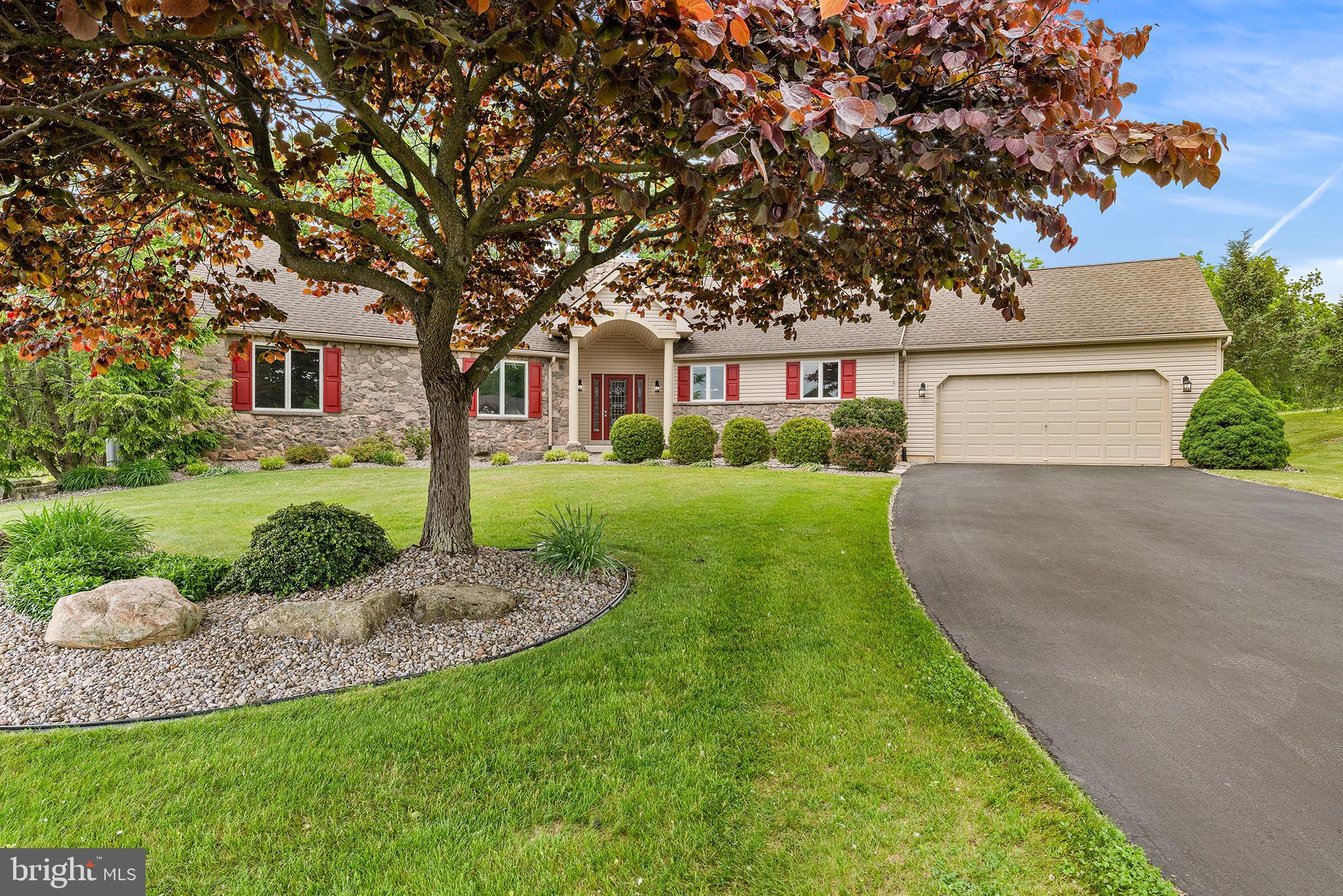 * OFFER DEADLINE 12 NOON 6/8 * Introducing this beautifully updated and spacious single-story ranch in the highly desirable Harvest Fields neighborhood. A large covered front porch leads into an impressive foyer accented by a striking stone feature wall, complemented by fresh paint, 9 FOOT CEILINGS, and recent SOLID OAK HARDWOOD flooring throughout. The expansive living room is filled with natural light from walls of windows and anchored by a dramatic floor-to-ceiling stone gas fireplace. Sliding glass doors open to an oversized paver patio overlooking the FENCED-IN BACKYARD with beautiful rocked landscaping beds, and situated on the 17th hole of the Shepherd Hills Golf Club - ideal for entertaining, relaxing, or play. The well-appointed kitchen features a center island, breakfast nook, solid wood Stofanak cabinets, pantry storage, and stainless-steel appliances. It flows seamlessly into the family room with a second gas fireplace and direct access to the patio. Nearby, you’ll find the oversized laundry room and entry to the attached two-car garage. The PRIVATE BEDROOM WING begins with a convenient half bath, a spacious primary suite with a large walk-in closet, and an ensuite bath offering a dual vanity, soaking tub, and walk-in shower. Two additional bedrooms share a Jack-and-Jill bathroom. A full unfinished basement provides abundant storage, with plumbing already in place for the opportunity to create additional finished living space. Ideally located within a short distance to Starbucks, Whole Foods, Target and Costco, as well as restaurants, shopping and easy highway access. This exceptional home is in the highly sought-after East Penn School District. Homes in this neighborhood and of this caliber seldom become available - this is a must-see.