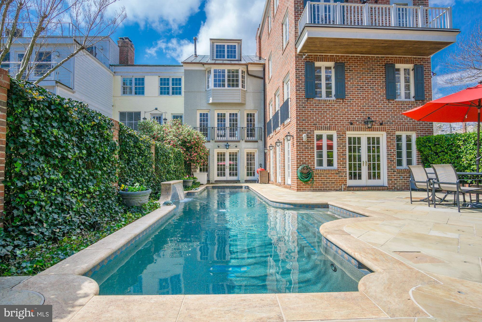 800 South Lee is a truly significant Old Town property in one of the finest locations in the South East quadrant.  It boasts a combination of primary features not found elsewhere: ample square footage, a large yard bordering protected green space, dedicated parking, a heated swimming pool, and modern construction in a historically-zoned district within walking distance to shops, restaurants, schools and steps away from Jones Point Park and the Potomac.   Situated on an oversized lot rarely found in Old Town, expansive green space affords the owner clear views over beautifully landscaped grounds that border protected parkland.  The unparalleled level of privacy in the expansive outdoor living space - featuring an amazing outdoor pool - set this property in a league of its own. With a handsome brick exterior, this 6000 square foot plus, 5-bedroom layout provides an array of options for living and entertaining.  Modern amenities, luxury finishes, amazing views, proximity to everything, and natural light further distinguish this Old Town gem.