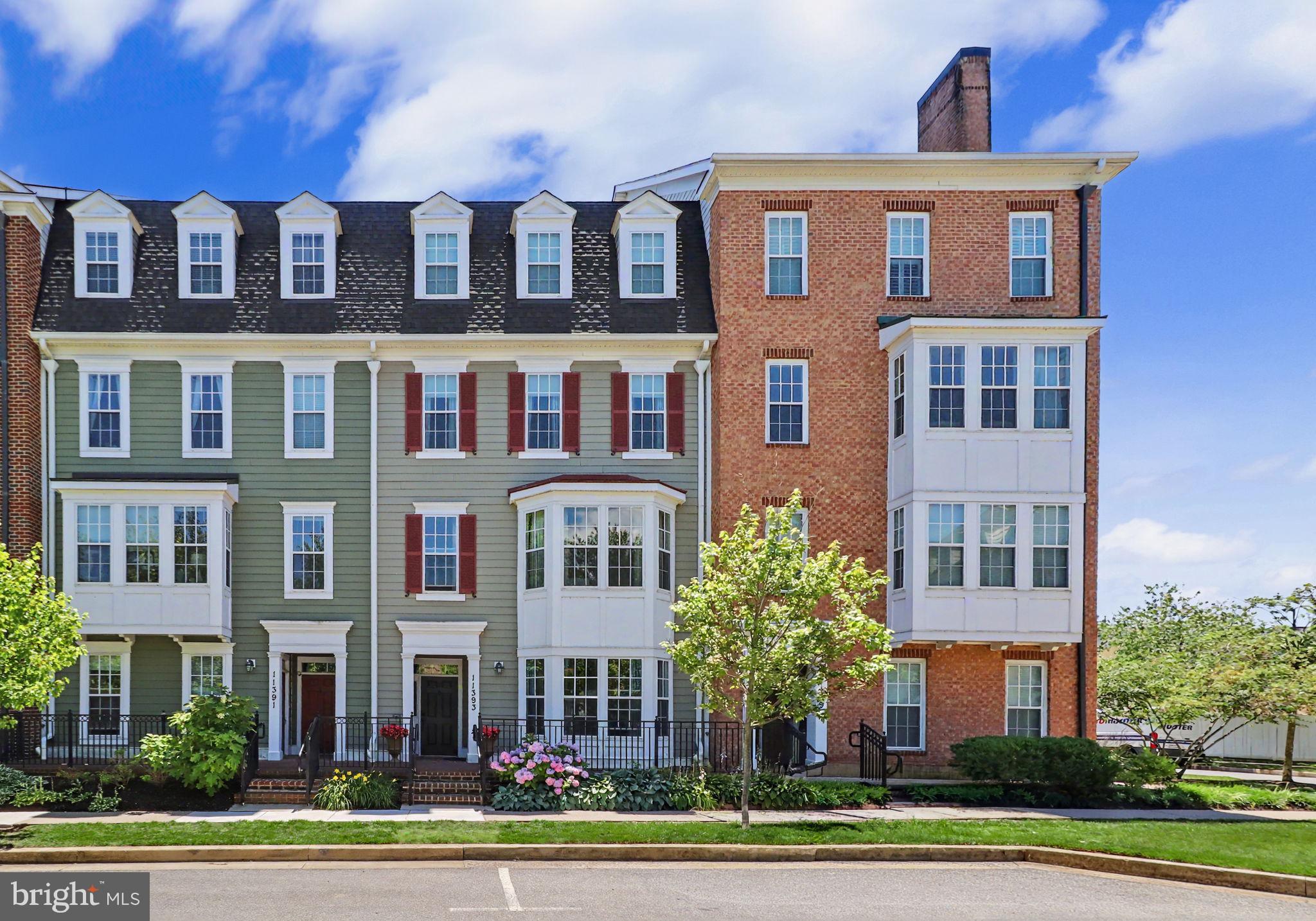 Former Bozzuto Red Maple Model Home! Stunning two-level luxury condominium in the highly sought-after Midtown District of Maple Lawn, ideally situated across from Midtown Park and community green space. This beautifully appointed former model home offers 2 bedrooms, 3 full bathrooms, a private home office, and a 1-car garage, showcasing exceptional upgrades and designer finishes throughout. Step inside to discover a welcoming entry-level office featuring custom built-in cabinetry and large sun-filled windows—perfect for working from home. A beautifully appointed full bathroom with a glass-enclosed shower completes the lower level. The upper level showcases the heart of the home with an open-concept design featuring gleaming hardwood floors, soaring ceilings, oversized windows, crown molding, custom millwork, and designer lighting. The gourmet kitchen is a chef’s dream, complete with granite countertops, stainless steel appliances, gas cooking, 42-inch cabinetry, a spacious pantry, and a breakfast bar ideal for casual dining and entertaining. The spacious living and dining areas provide the perfect setting for everyday living and hosting guests. Retreat to the luxurious primary suite featuring a walk-in closet and a spa-inspired bath with dual vanities and a walk-in shower with built-in seating. A generously sized second bedroom, an additional full bath with a relaxing soaking tub, and a convenient laundry room complete the upper level. Enjoy Maple Lawn’s award-winning amenities, including a community center, fitness facilities, outdoor pool, tennis and basketball courts, playgrounds, picnic pavilions, and walking and running trails. Restaurants, shopping, grocery stores, salons, and community events are all within walking distance. Move-in ready and impeccably maintained, this exceptional former model home offers the perfect blend of luxury, convenience, and lifestyle.