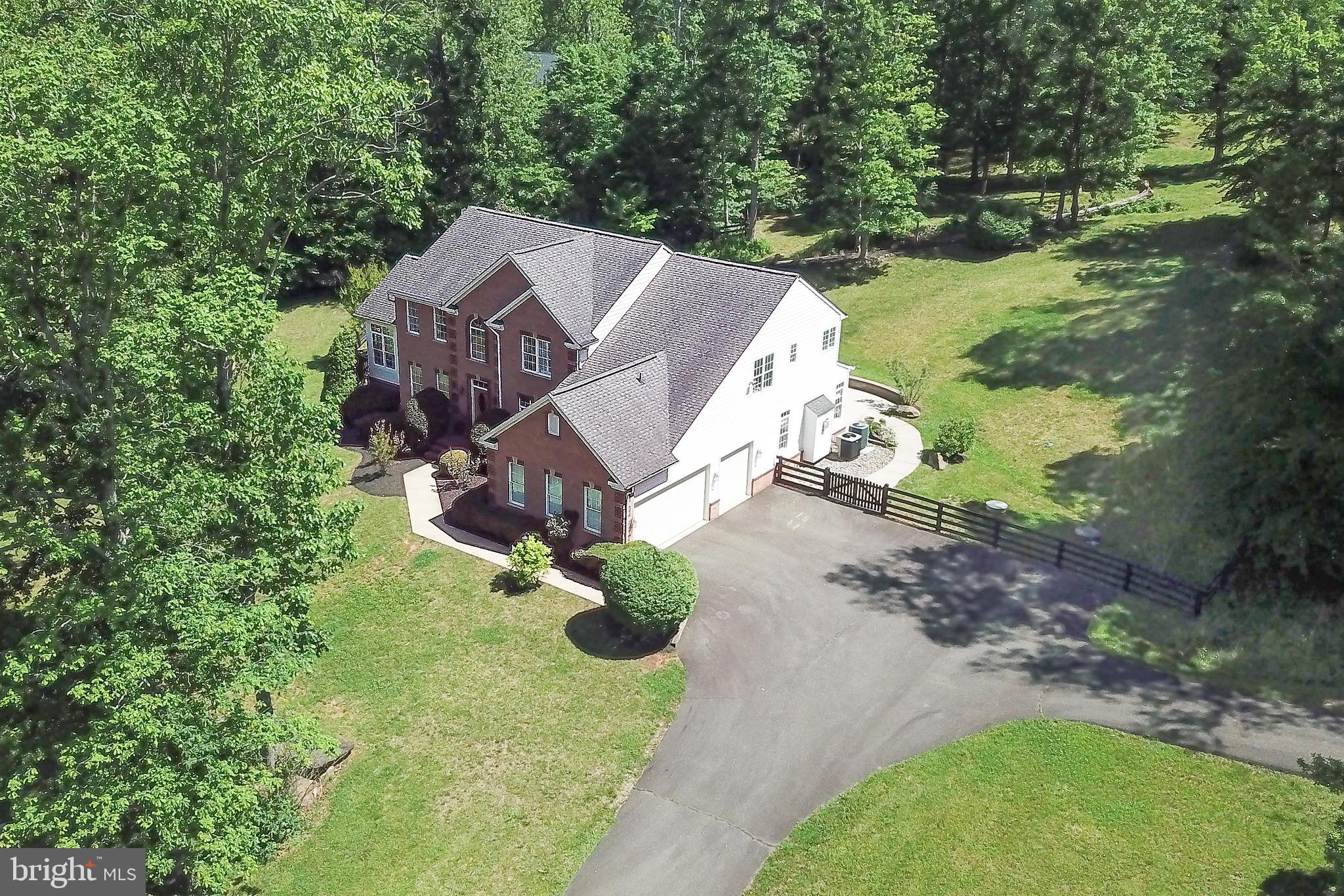 Nestled on 4 private acres, this stately Colonial offers nearly 6,000 square feet of exceptional living space, blending timeless elegance with modern comfort. From the moment you enter, you'll appreciate the beautiful hardwood flooring, upgraded trim package, and spacious open layout designed for both everyday living and entertaining.
The main level features a private study, formal living room, elegant dining room, and a welcoming family room highlighted by a cozy gas fireplace. The gourmet kitchen is the heart of the home, boasting a large center island, abundant cabinetry, and seamless flow into the sun-filled morning room and stunning solarium.
Upstairs, the luxurious Primary Suite serves as a private retreat with two walk-in closets and a spa-inspired bath featuring a soaking tub, separate standing shower, and double vanity.
The fully finished lower level is an entertainer's dream, offering a spacious recreation room complete with a full wet bar and a dedicated movie theater for unforgettable gatherings and movie nights.
Step outside to enjoy the beautiful patio with a built-in firepit, overlooking the large fully fenced backyard. The expansive 4-acre setting provides privacy and room to enjoy the outdoors, while a storage shed adds additional convenience.
This remarkable property offers the perfect combination of luxury, functionality, and privacy in a picturesque setting.