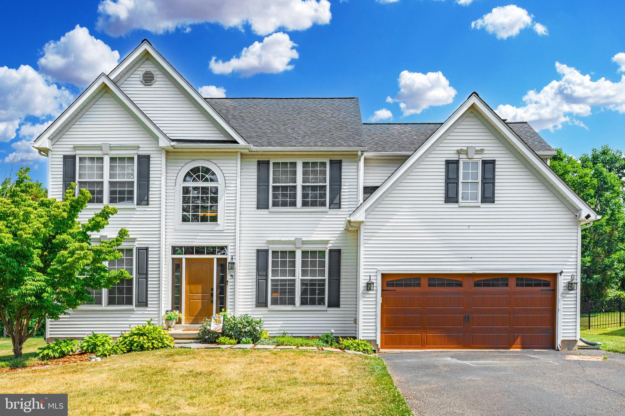 Welcome to this beautiful 4 bed, 2.5 bath colonial located in the lovely community of Chestnut Grove. Boasting over 2400 square feet, a lovely 2 story foyer, open kitchen/living room floor plan, 2 car garage, a gorgeous flat backyard and so much more! Upon entering the home into the foyer you are welcomed with tons of natural light. Here you will find a view of most of the main level including the dining room, living room, entry into the kitchen, and even through to the backyard. Gorgeous wood floors throughout this main level make the space flow & feel so cohesive. The dining room and living room are open to one another and the spaces could easily be flip flopped! The kitchen was just recently refinished and it warm and inviting. Beautiful green cabinetry, wood countertops, an island and coffee bar, and a live edge bar top facing the family room. This is the perfect space for entertaining! Sliders lead out to the backyard and the family room has a wood burning brick fireplace and 4 big windows just oozing with sunlight. Finsihing off this level is of course a half bath, laundry/mudroom and 2 car garage. Upstairs the primary bedroom has an ensuite with soaking tub, stall shower and double vanity as well as a large walk in closet! There are 3 additional bedrooms and a nice size full hall bathroom. Plenty of space for the family/home office! The lower level is just waiting to be finished! Could be an additional 1000 square feet if you needed the extra rec room! Currently it is great for storage! And we cant forget about the backyard. It is flat, perfect for playing ball or maybe even a pool, one of the largest, flattest lots in the neighborhood! Out here you will find a lovely paver patio & gazebo. Do not miss your chance to make this yours! Welcome Home!!