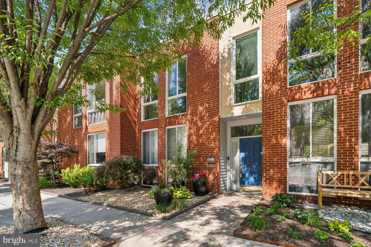 Don’t miss this rare opportunity to live in a highly coveted private neighborhood in Federal Hill—complete with five-car parking, a true rarity in the city. This brick-front townhome has been thoughtfully updated throughout, featuring a stunning kitchen with Wilsonart quartz countertops, an island with seating, open shelving, abundant custom white cabinetry, a pantry, and stainless-steel appliances. Fresh paint and new hardwood floors (2023) extend across the entire main level, creating a bright and refined living space. The open-concept layout includes a dining area with modern lighting and a spacious living room that flows seamlessly through newer sliding glass doors to a large wood deck—perfect for outdoor relaxation and entertaining. A stylish powder room with a pedestal sink completes the main level. Upstairs, you’ll find two generously sized primary bedrooms with modern lighting. The first primary suite includes a ceiling fan and slider to a private second-story deck, boasting corridor water views, ideal for enjoying harbor sunrises. The en-suite bath features a walk-in shower, double vanity, and large walk-in closet. The second primary bedroom offers flexibility and could be reconfigured into two separate bedrooms, each with its own closet and egress window. The lower level provides a versatile space that can function as a den, office, or third bedroom, along with a full bathroom with tub-shower and a dedicated laundry room. Parking is unmatched, with a two-car garage, an additional two-car parking pad, and a fifth dedicated space. A charming front garden with programmable lighting enhances curb appeal. Notable updates include: hardwood floors (2023), HVAC (2020), carpeting (2019), both sliders (2017), TPO roof (2016), lower deck replacement and upper deck addition (2019), and replaced garage motor / keypad (2019). Ideally located just steps from Federal Hill Park, blocks from the Inner Harbor, and within walking distance to stadiums, restaurants, shopping, and nightlife. Enjoy fireworks on the Fourth of July and New Year’s Eve right from your own deck. With quick access to I-95, commuting is effortless. This home truly checks every box—unbeatable parking, prime location, and exceptional indoor-outdoor living.