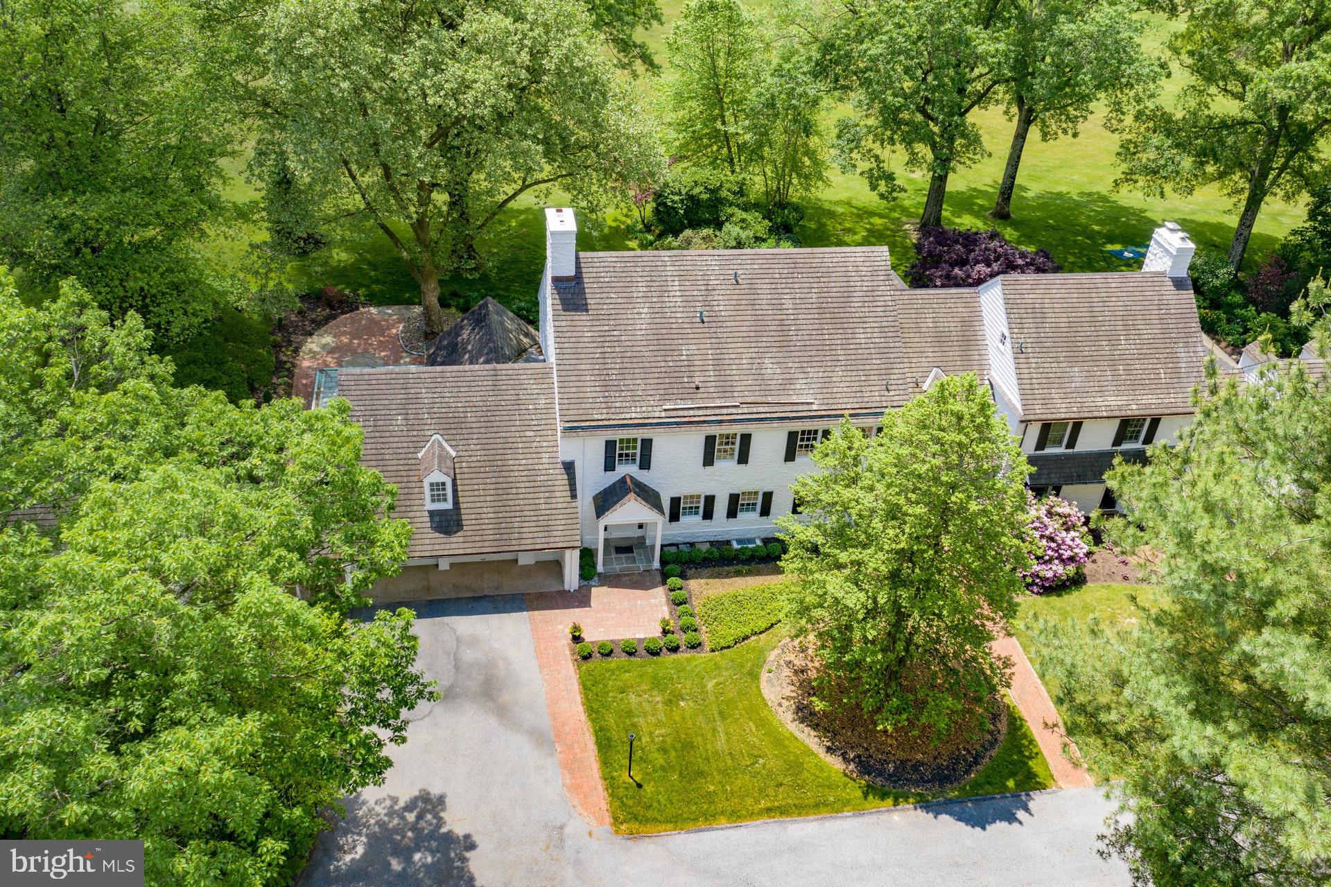 VIRTUAL TOUR AVAILABLE ON LINE. Visit  https://my.matterport.com/show/?m=H9S1LCdZGqM&play=0&wh=0&ts=2&guides=0&brand=1&vr=1 for a 3D walkthrough, and  https://www.seetheproperty.com/r/348786 for photos, floorplans & more! On a private road in a world-class neighborhood, surrounded by mature trees and manicured lawn, this exceptional home has panoramic views over 22 acres of meticulously tended grounds, within walking distance to the Weyhill Golf Course of the Saucon Valley Country Club.  Beautifully redone in 2020, with every amenity one would expect, there are walls of windows in every room to frame the pastoral and protected vistas.  Part of a lovely eight home enclave that is reminiscent of a New England village green, this exceptional home is tucked away at the end of the road, in a location that invites you to linger and enjoy the beauty of the environment. The exquisite remodel and gracious new design is a fabulous surprise.  It offers a wonderful flow for entertaining, with rooms opening onto two terraces, a covered porch, and lovely gardens.  An enormous great room boasts floor-to-ceiling windows, French doors, formal fireplace and breakfast alcove. The breathtaking new kitchen has the latest in high-end appliances, and opens to an adjacent dining/family room with wet bar while a first floor den is an additional get away.  Throughout, attention to detail is evident in the beautiful wood floors, crown moldings and new windows, while an elevator accesses three levels. The brand new master suite will delight with a generous master bedroom, 9 foot ceilings, custom walk-in closet and breathtaking views.  An elegant master bath is a soothing addition with soaking tub, exquisite vanities, walk-in shower for two and, again, exceptional views.  Two additional en suite bedrooms and new laundry room complete the second floor.  Rarely does a home offer such a classic and elegant ambience, in a cutting edge design, surrounded by an outside environment that invites you, daily, to walk the acreage and private roads.